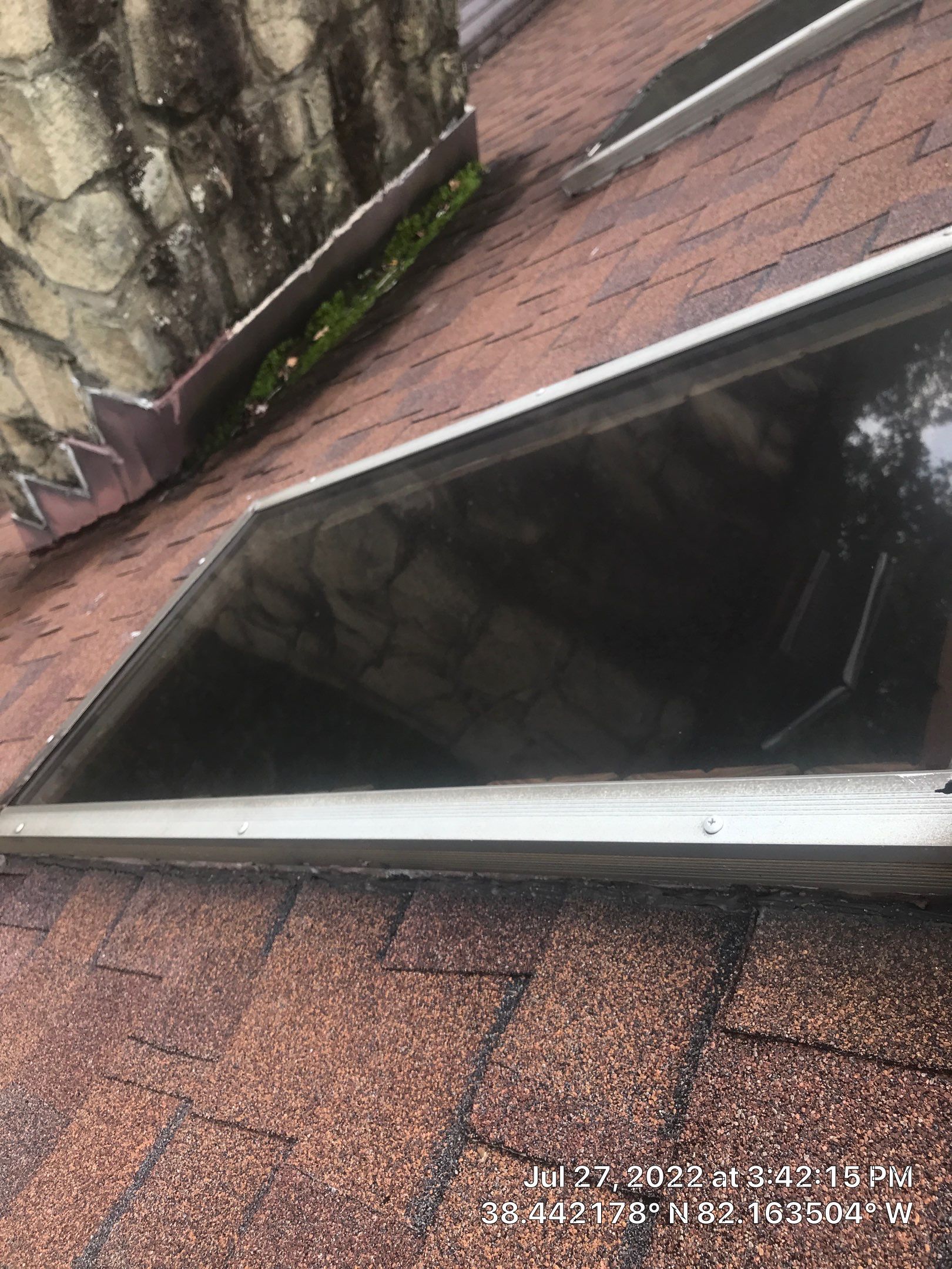 Shingle Roofing with Velux Skylight replacement and stone chimney flashing  by Secure Construction Company Inc
