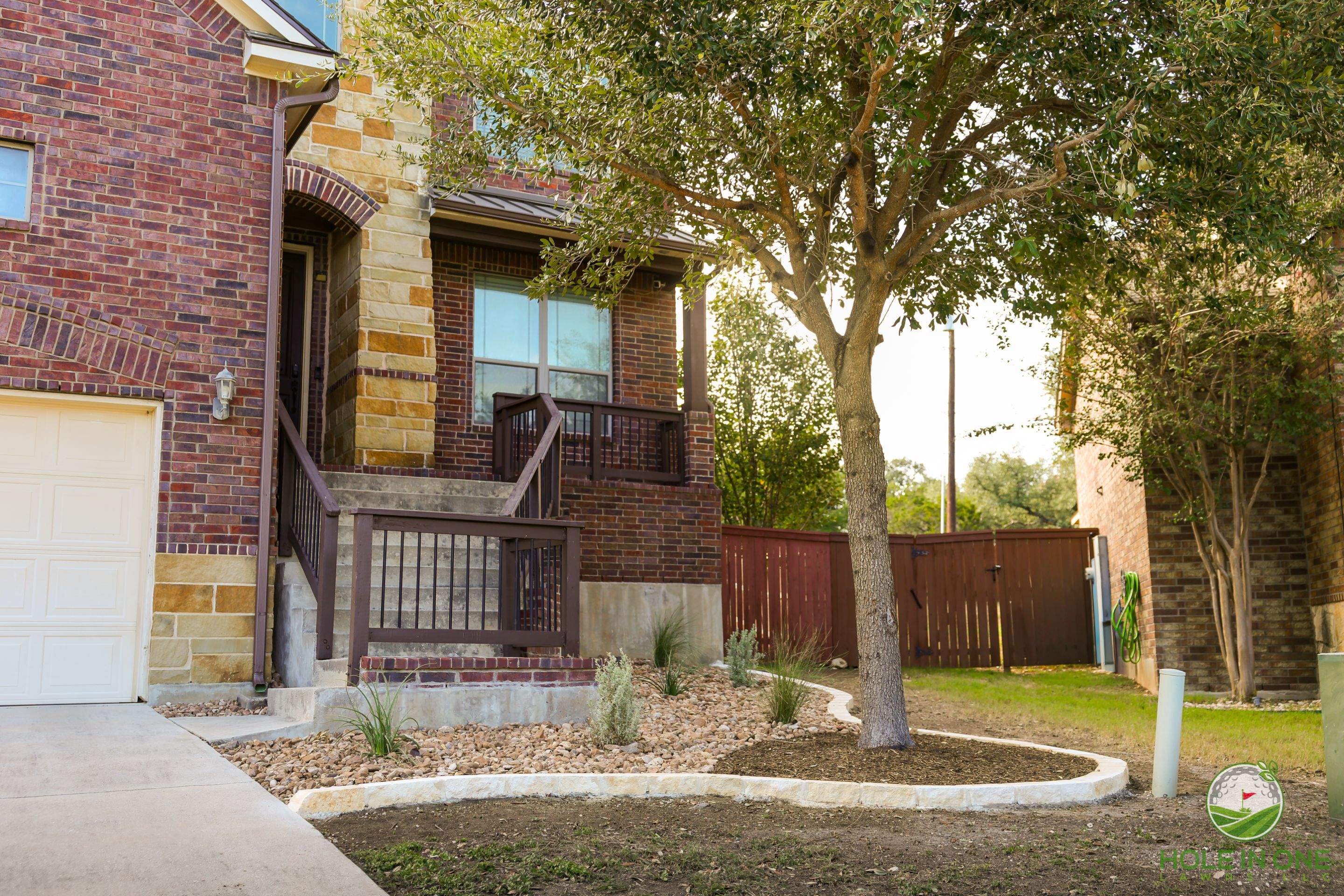 Low-Maintenance Front Yard Xeriscape with Chopstone Border, North San Antonio TX by Hole In One Lawns, LLC