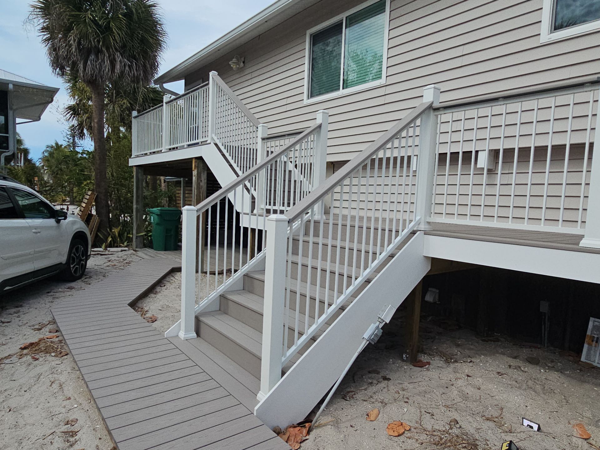 Elevated Composite Deck and Symmetrical Staircase Replacement in Englewood by Smirnov Construction Inc