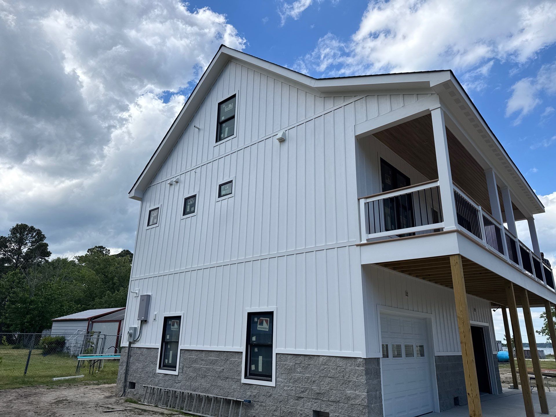 Two-Story Custom Home With Board and Batten Siding by Cade Construction