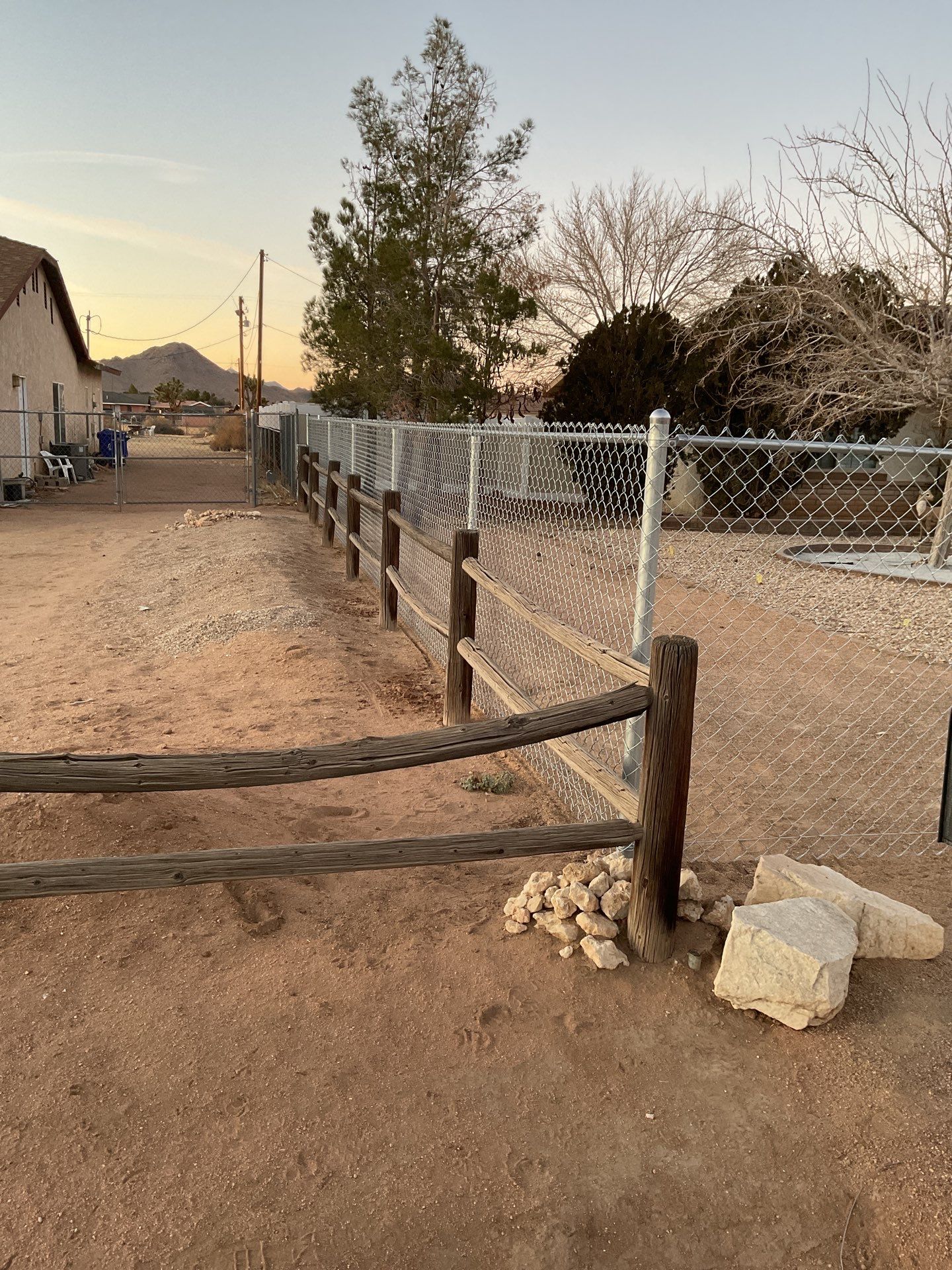 Sleek chain link fence installation with a solar motorized gate by Fence Guys Inc.