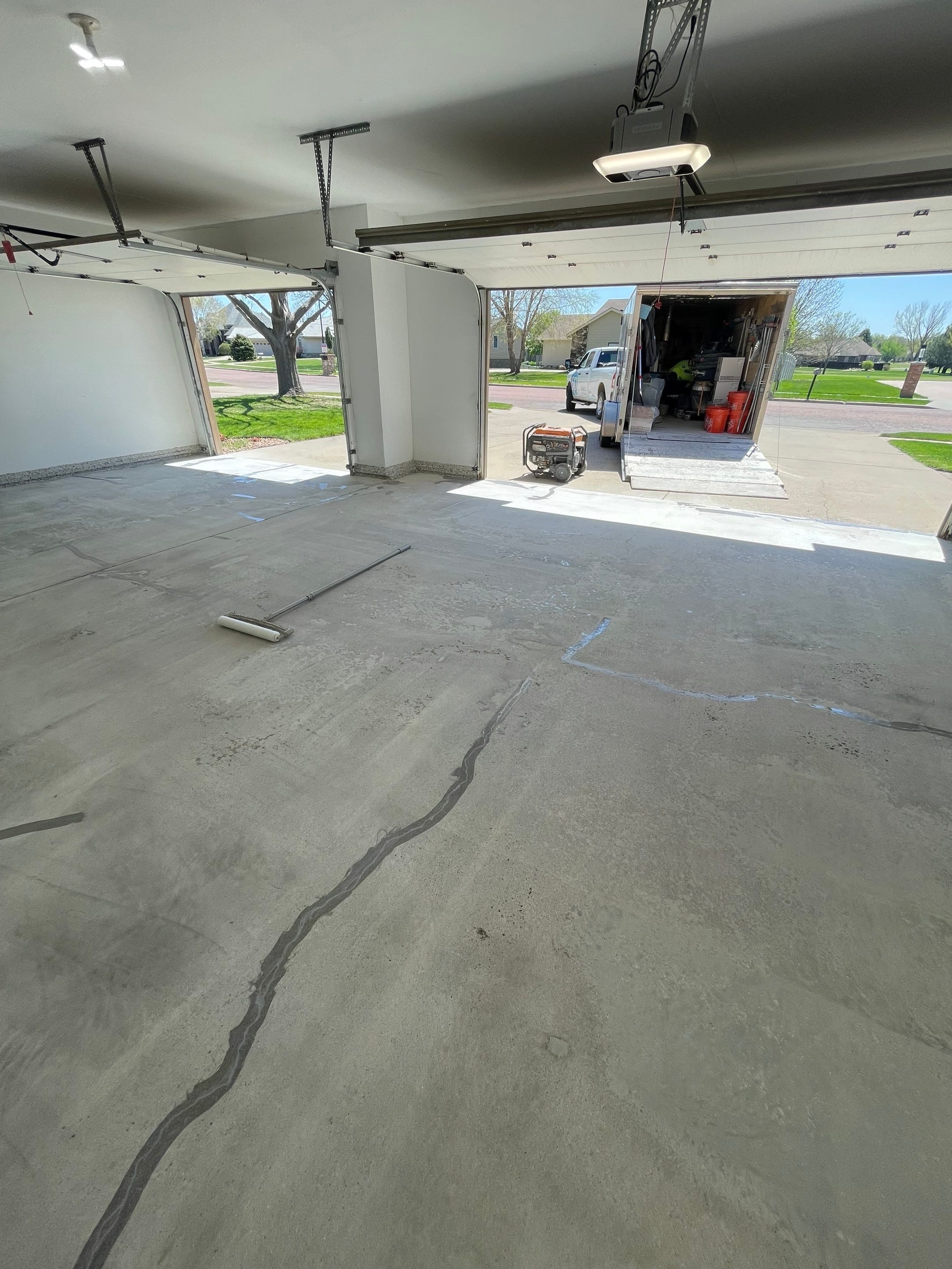 Yankton Garage Floor Restoration with Gray Speckled Epoxy Coating by Select Painting, Coatings & Garage Cabinets