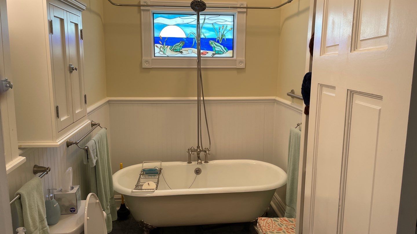 Shower Transition Highlighting Stained Glass Window by Footprints Floors of Coastal Carolina