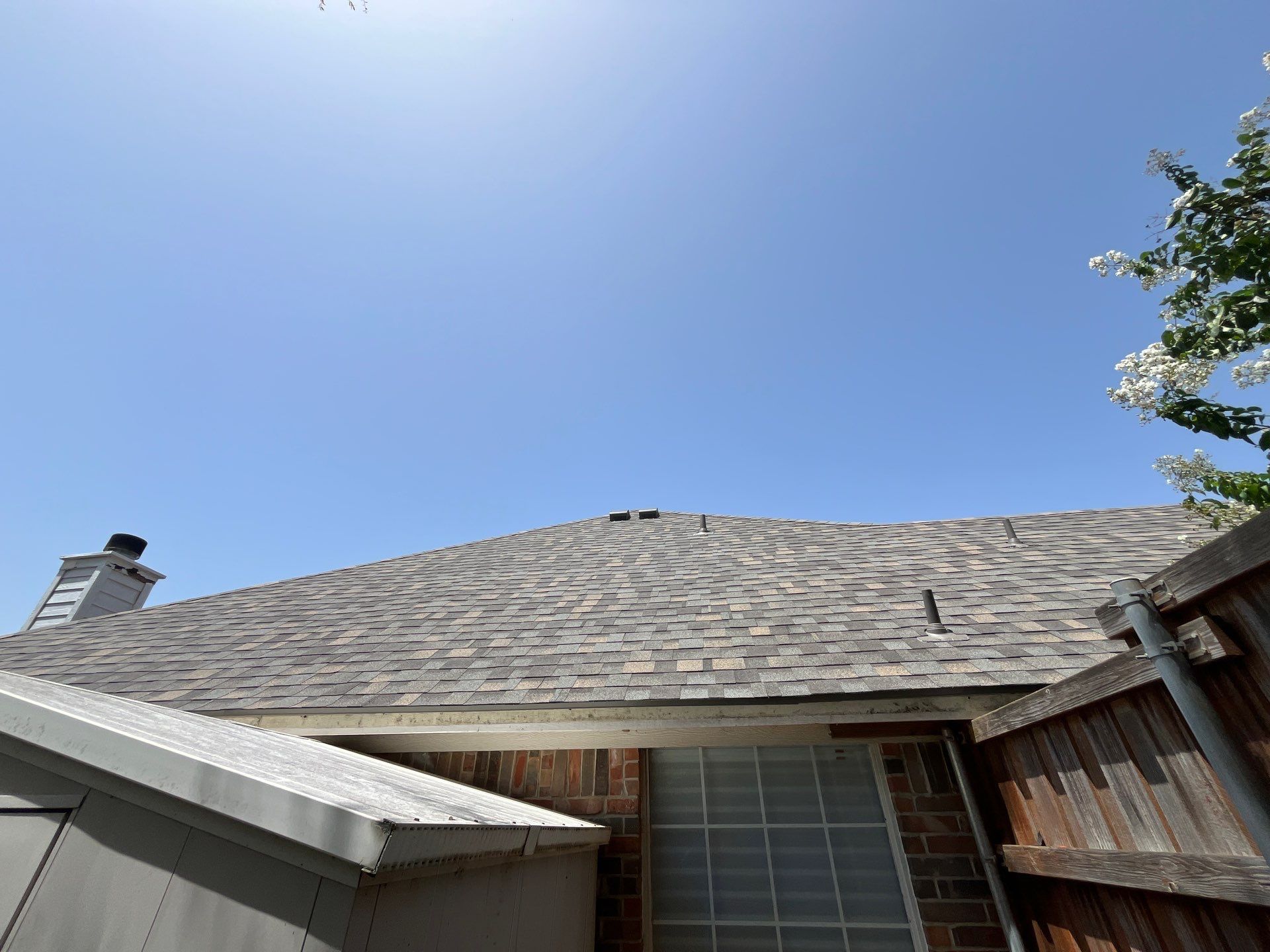 Red brick with IKO Cornerstone  by Tejas Roofworks + Restoration