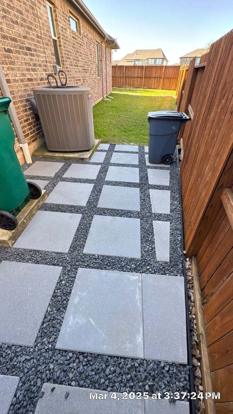 🌿✨ Darlene & Andrew’s Amazing Curb Appeal Transformation  Some projects are more than just landscaping—they’re a conversion of curb appeal from the ground up. For Darlene & Andrew, Alejandro and the Texas Urban Team designed and delivered a complete solution that reshaped their flower beds, solved drainage challenges, and gave new life to the sideyard.  💡 From planning to execution, every step was tailored to build both beauty and functionality:  🌸 Flower Beds, Reinvented  Demolition of old beds, plants, and mulch.  Fresh soil preparation, weed protection, and a brand-new retainer wall built with hand-cut stone and decorative caps.  Carefully selected plants and garden mix to ensure health and visual harmony.  💧 Drainage & Irrigation Upgrades  Outdated corrugated pipes replaced with PVC drainage lines to carry water safely away from the foundation.  New irrigation system combining drip lines and sprinklers—watering plants while keeping the house walls protected.  Sideyard drainage extended with catch basins and PVC piping to prevent water pooling and foundation stress.  🚶 Functional Sideyard with Walkway & Trash Area  Graded and leveled sideyard to manage runoff.  Installed a modern gravel and paver walkway for easy access.  Built a firm and tidy concrete-paver pad for trash containers—making the space both practical and polished.  🛠️ Stonework & Craftsmanship  Every stone in the retainer wall was cut, set, and secured by the team of handcrafters, ensuring a durable build that doubles as a design statement.  ✅ Outcome: Darlene & Andrew’s property now has better drainage, a clean and organized sideyard, and elegant new flower beds—all designed for long-term durability and lasting beauty.  📢 Before hiring anyone, review our portfolio. Our work speaks louder than words—each project is a blend of function, protection, and design crafted to last. by Texas Urban Elements