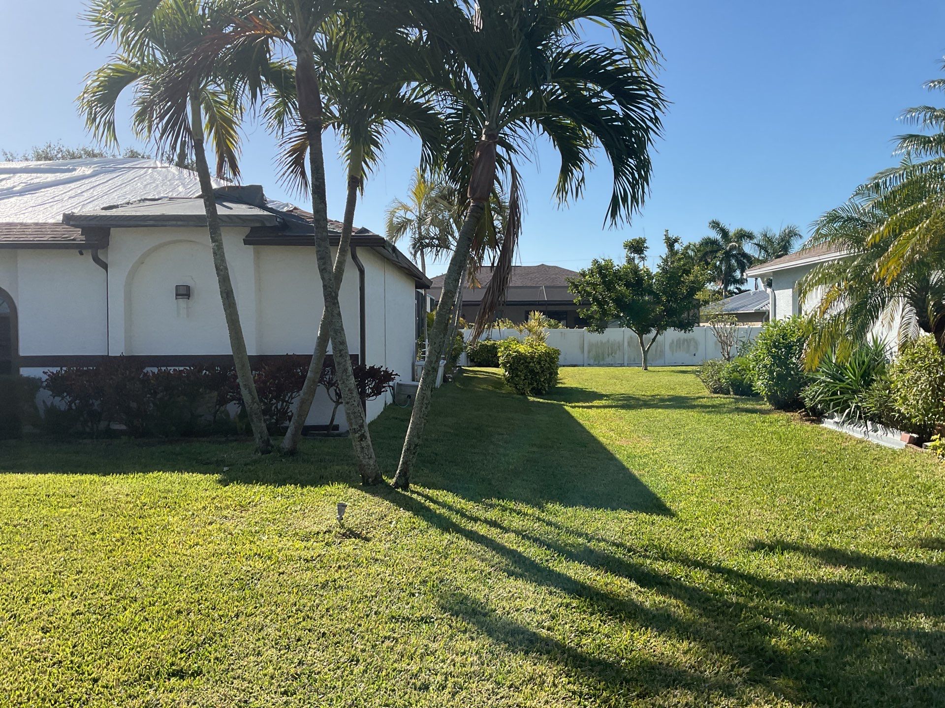 Brown Gutter + White and Brown Downspouts in Cape Coral FL by Gutter Professors