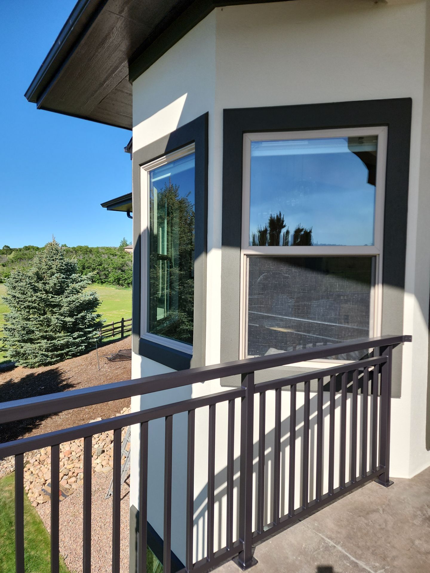 Castle Rock Elegance: White Stucco Exterior with Bold Tricorn Black by J&M Painting LLC
