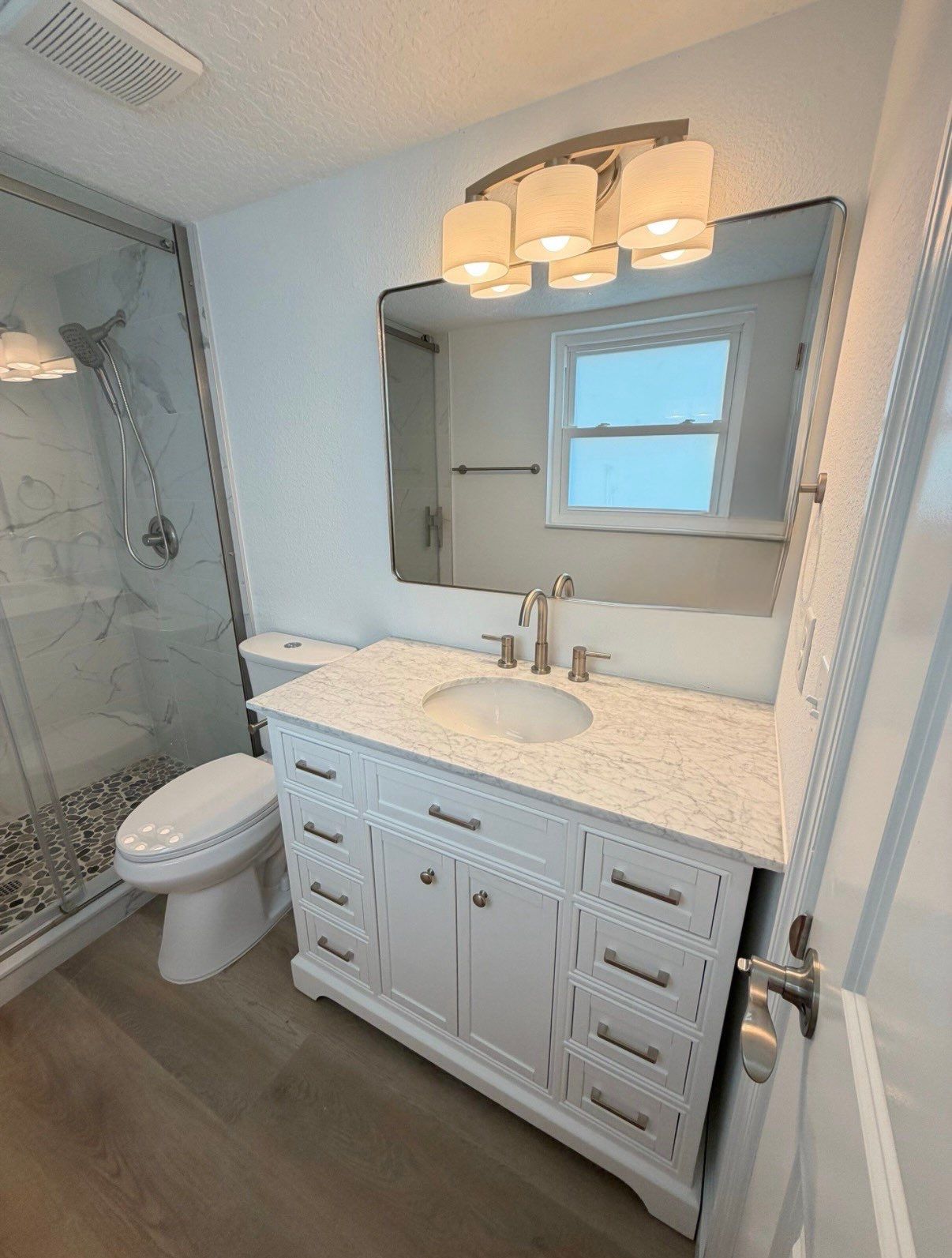 Full Condominium Remodel Featuring Aubrey Oak Flooring In Daytona Beach by Acies Renovations