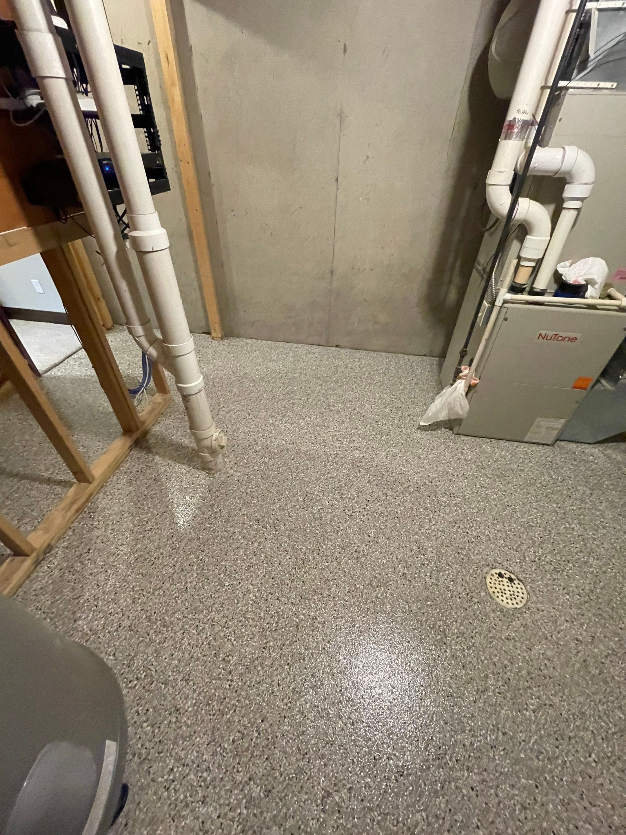 Sioux Falls Basement Floor Transformation with Durable Epoxy Flake Coating by Select Painting, Coatings & Garage Cabinets