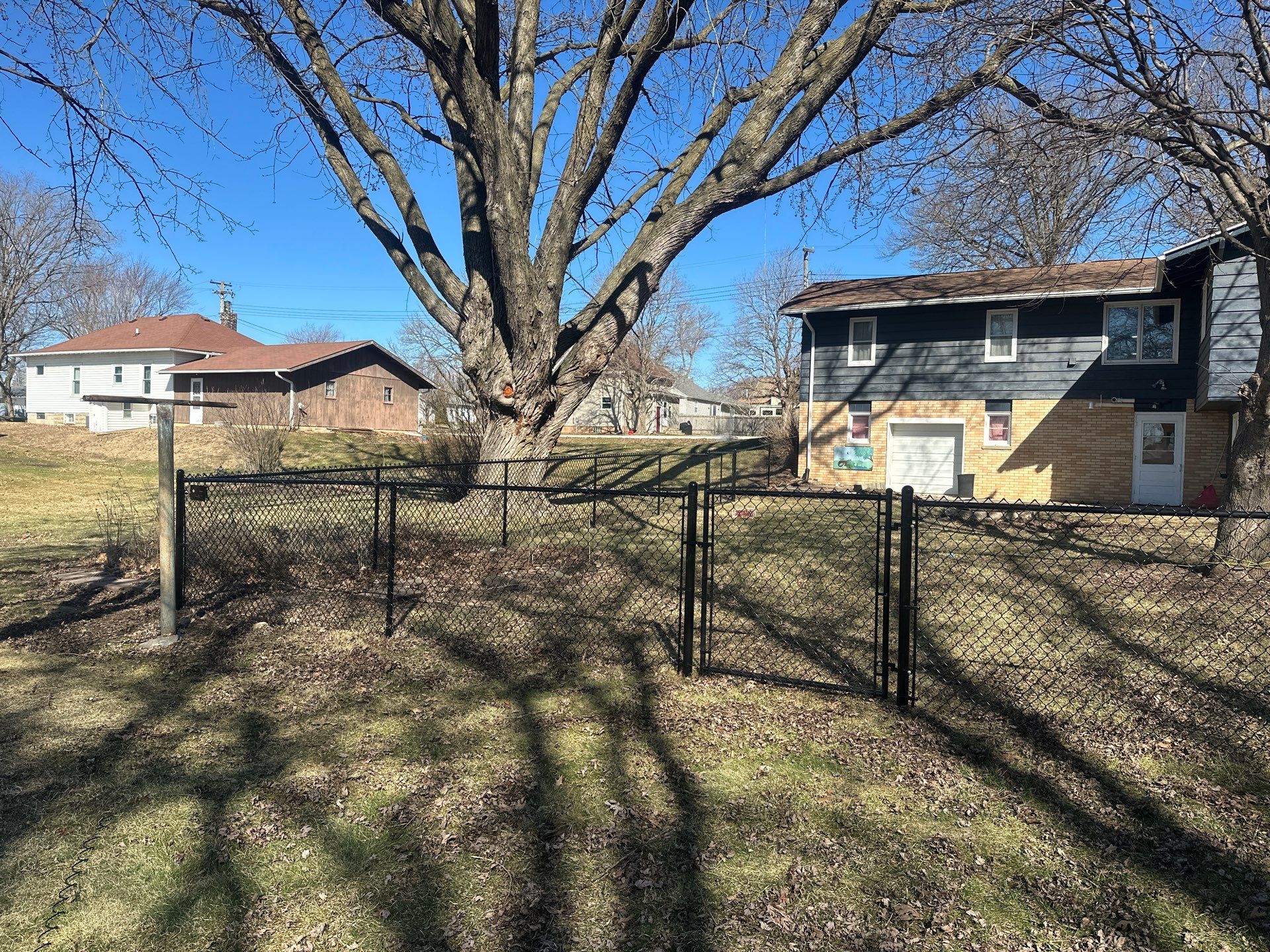 Black Chain Link Fence Installation with Double Gate in Grundy Center by Perfect Picket Fence and Stain