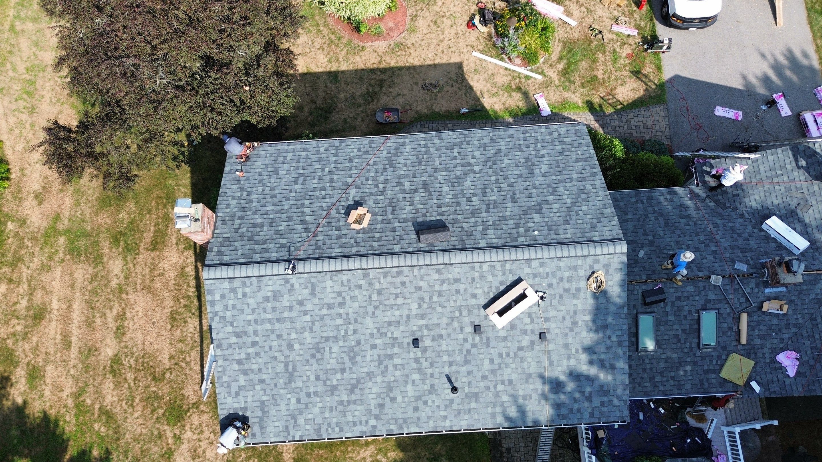 Complete Roof Replacement with Chimney Flashing, Gutter Guard System, and Vinyl Siding Repairs by Mighty Dog Roofing of Greater Middlesex County