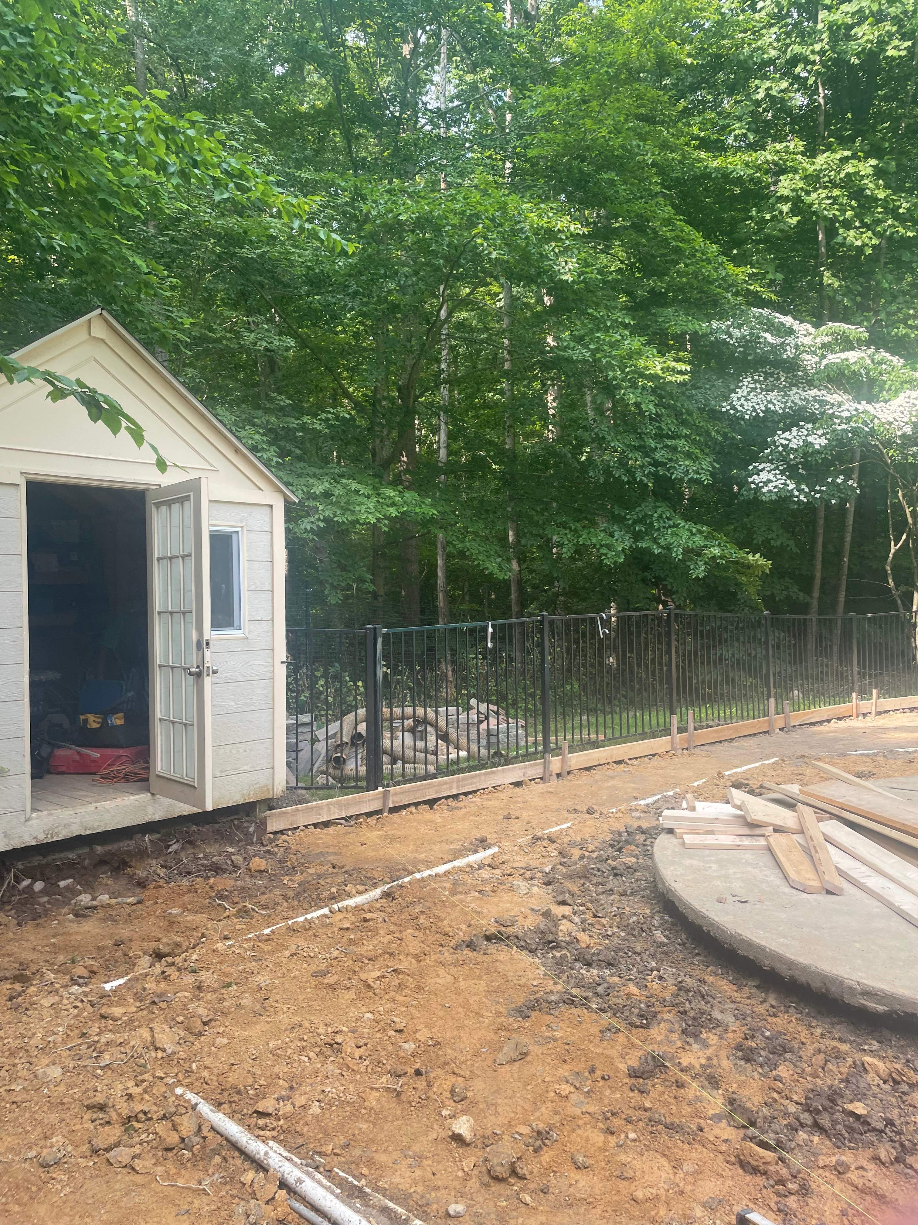 Pool Surround remodel with retaining walls, new waterfall and water slide by Fairfax Contractors, LLC