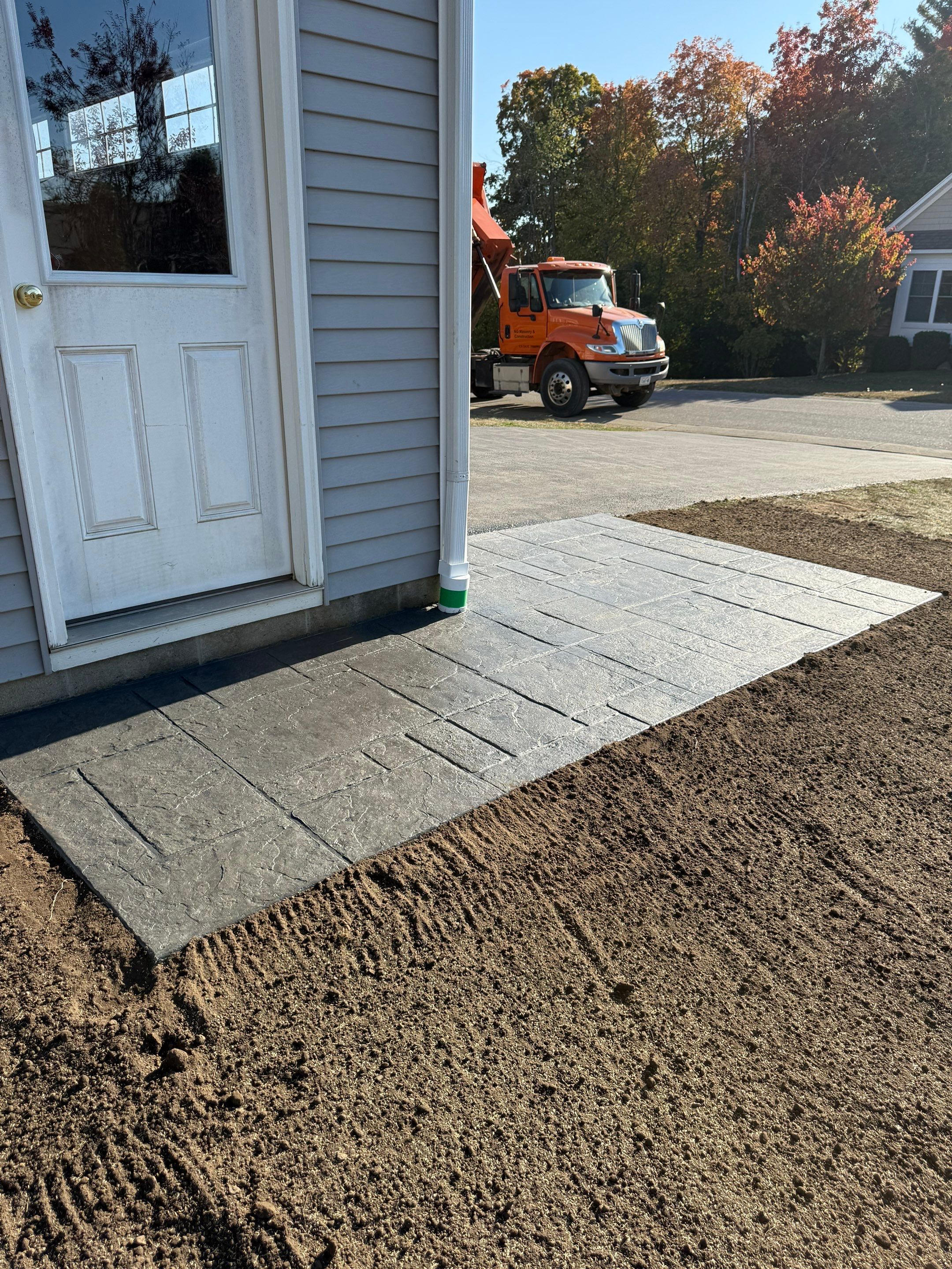 Stamped English Rivenstone concrete patio and sidewalks  by NG Masonry & Construction LLC