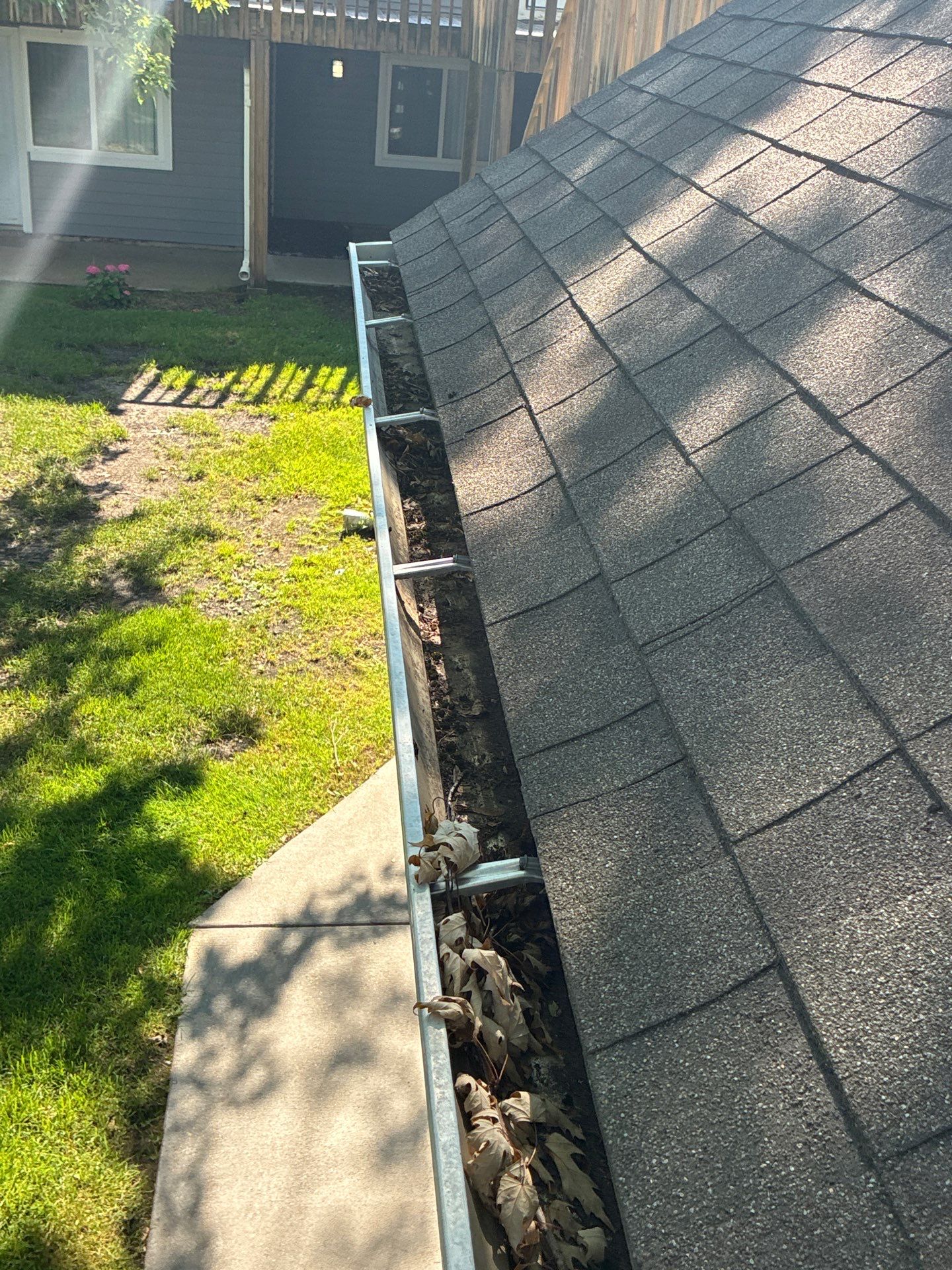 Commercial gutter cleaning Saginaw & Bay City, MI before photo with filled gutters