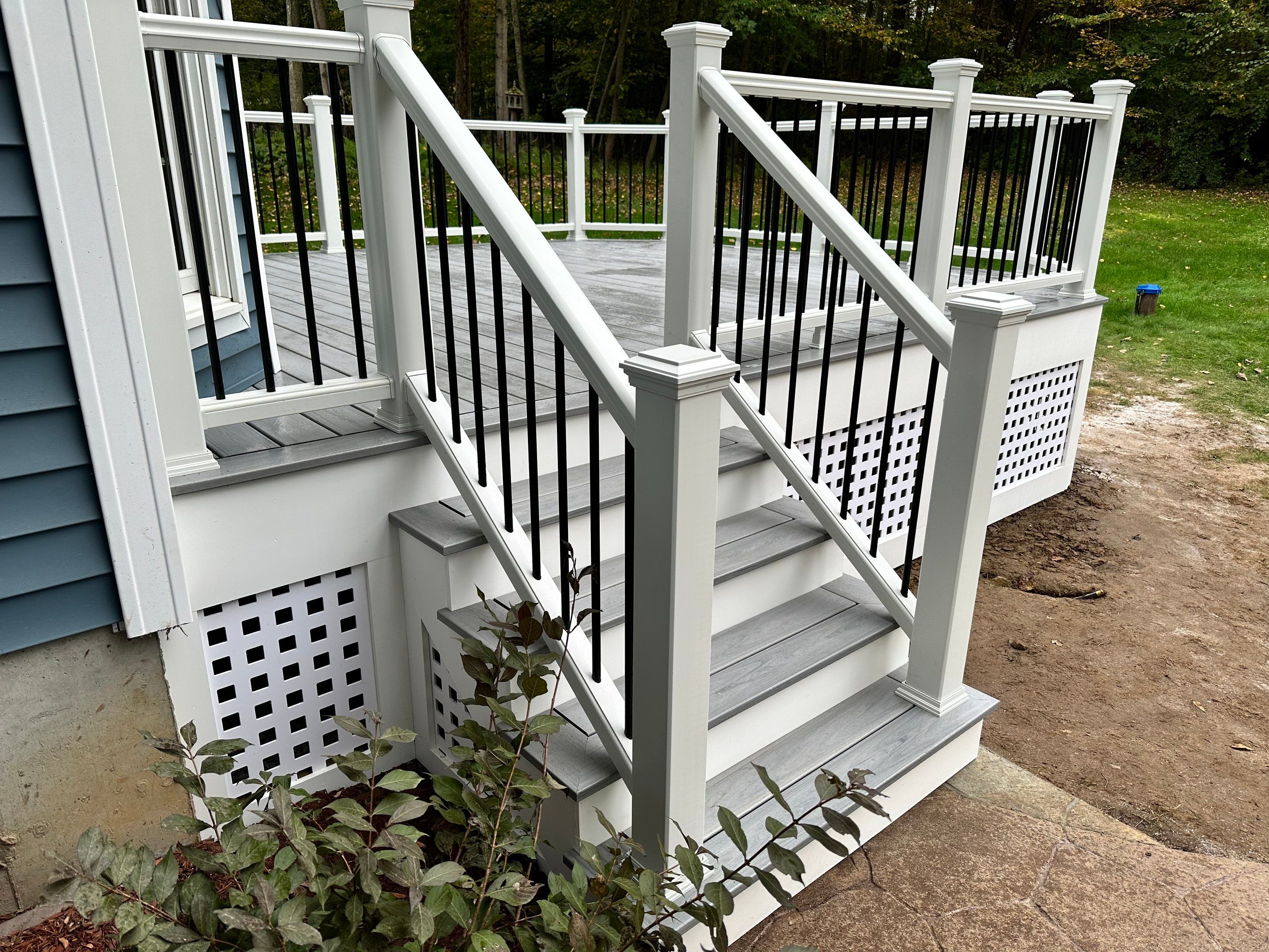 Deck replacement using Trex lineage Rainier with angled edges, Transcend cocktail rail and lattice. by DiGiorgi Roofing and Siding Inc