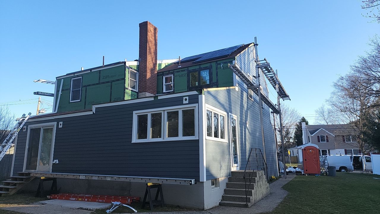 James Hardie siding, new metal roof and couple windows being installed. by UBrothers Construction