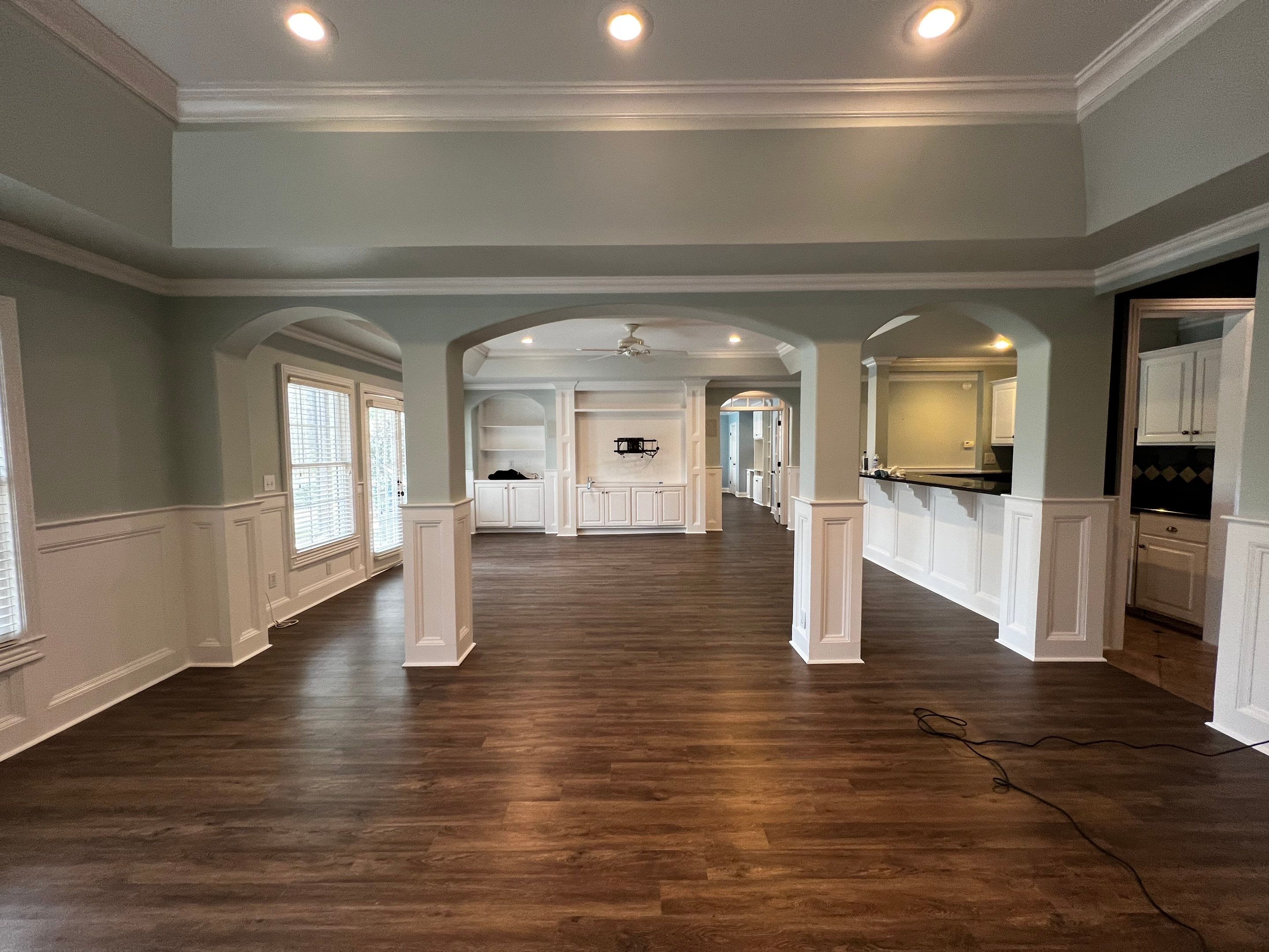 Finished Basement Remodeling with Dark Wood-Look Flooring and Custom Wainscoting by Swift Home Renovations 