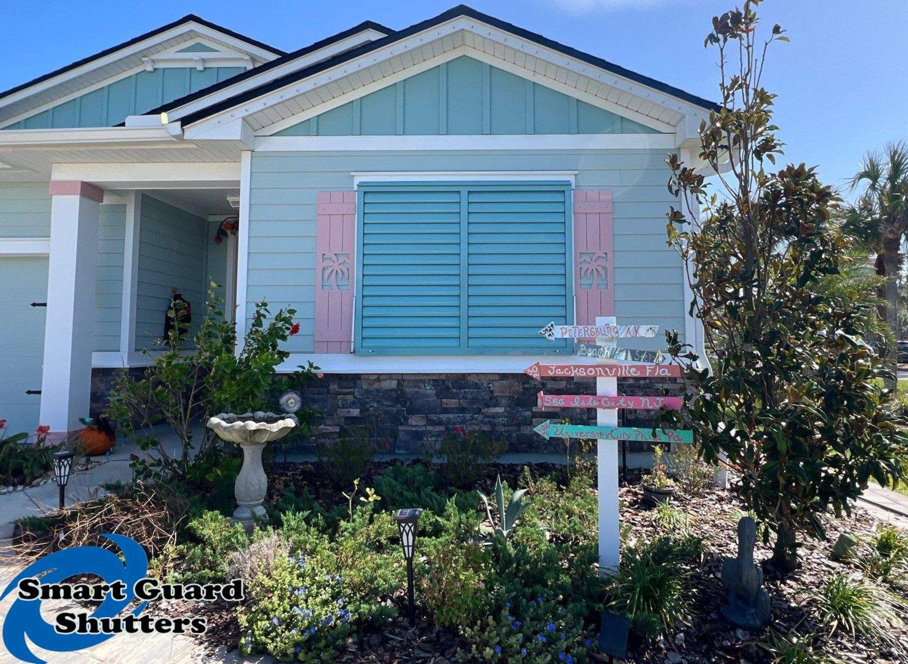 Impact Bahama Shutters in Pastel Turquoise by Smart Guard Shutters