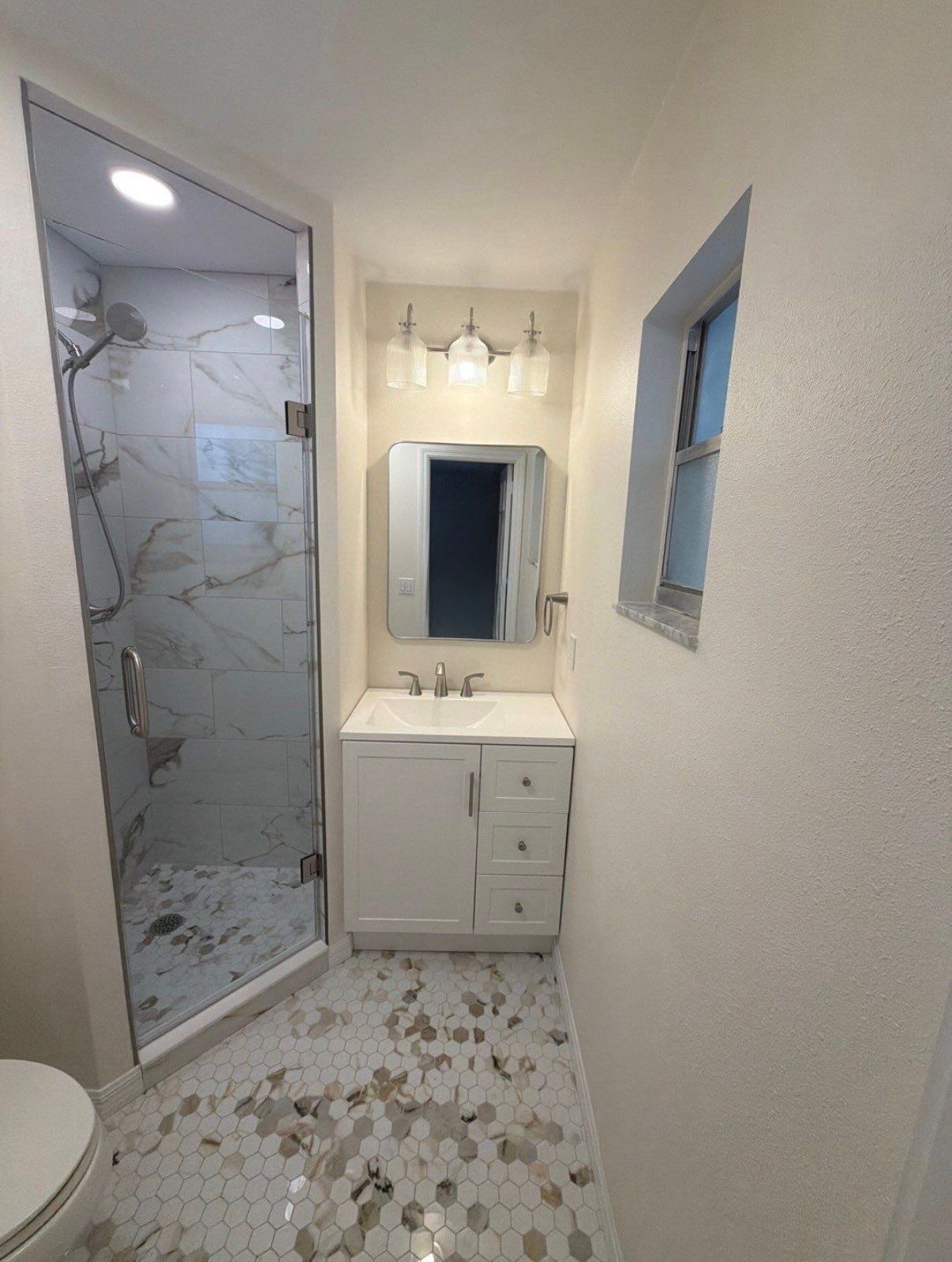 Modern Bathroom Remodel Featuring Marble Tile in Ormond Beach by Acies Renovations