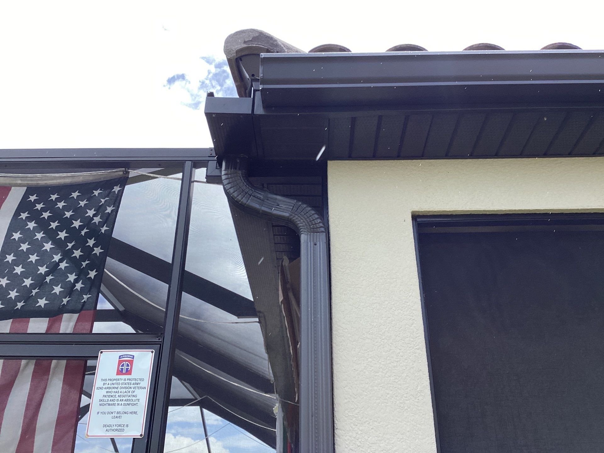 Musket brown seamless gutters with splash guards, new downspouts, and extensions in Bradenton, FL by Gutter Professors