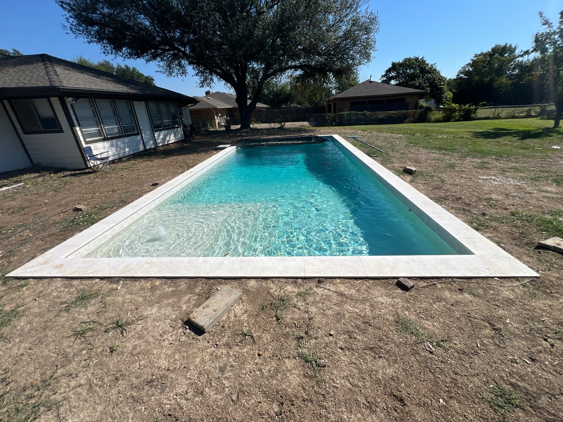 Crisp Geometric Pool with White Coping by Pinnacle Pools and Spas - DFW