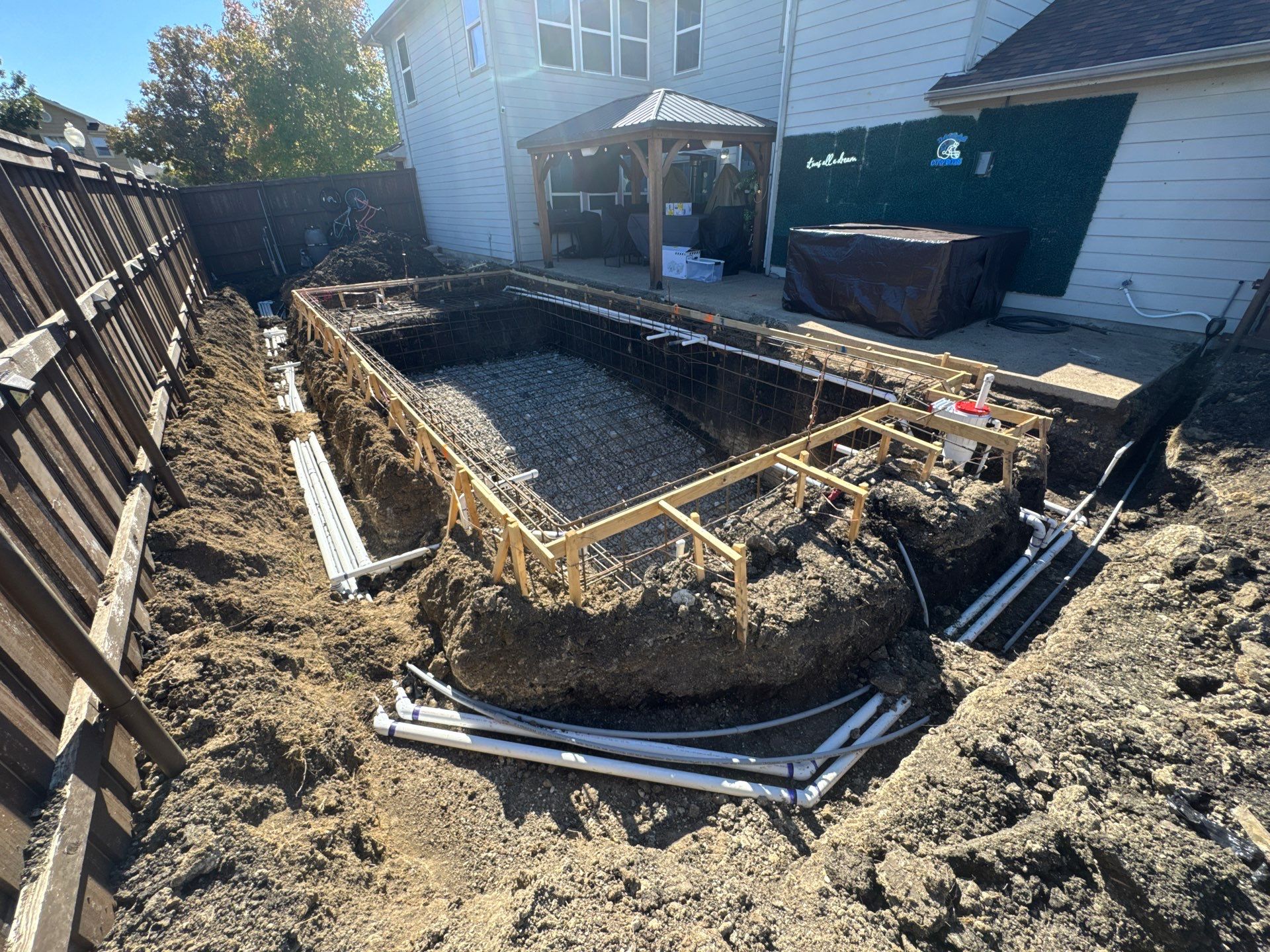 Pool with Turf and Raised Wall by Pinnacle Pools and Spas - DFW
