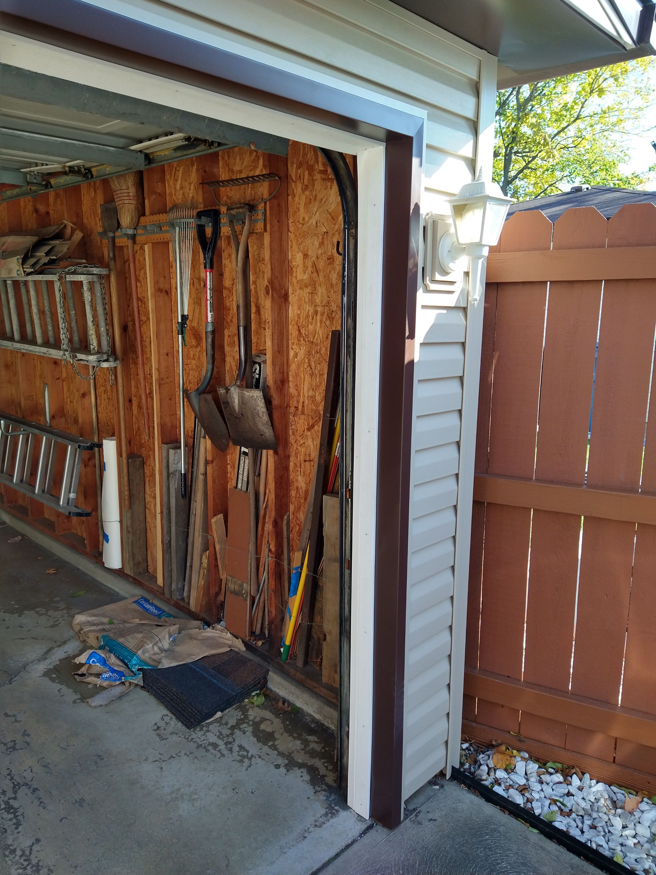 Siding Installation using Norandex woodsman dl-5 white woodgrain vinyl by Absolute Roofing and Construction