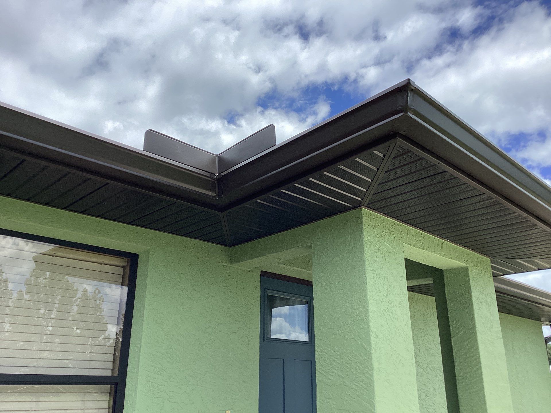 Musket brown downspouts with 6-inch K-Style gutter installation in Myakka City, FL by Gutter Professors