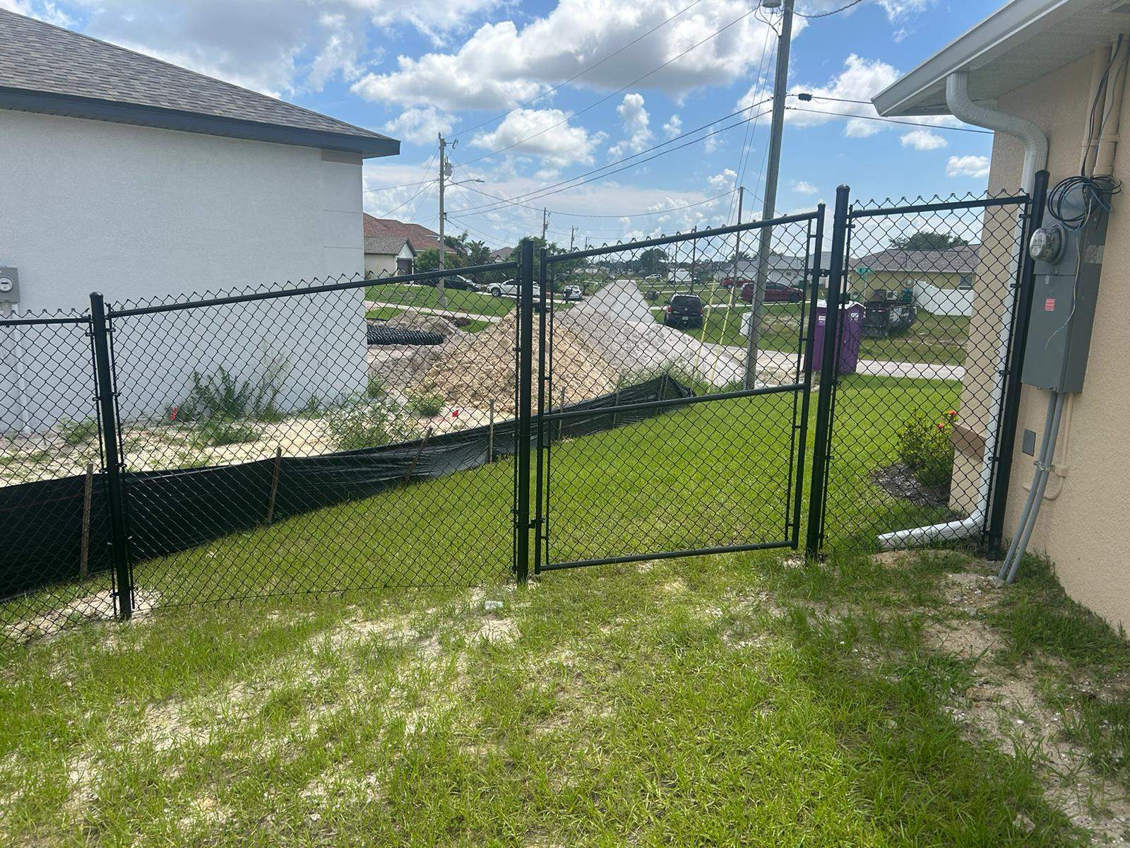 Black Chain Link Perimeter Fence and Utility Enclosure in Cape Coral by True Fence LLC