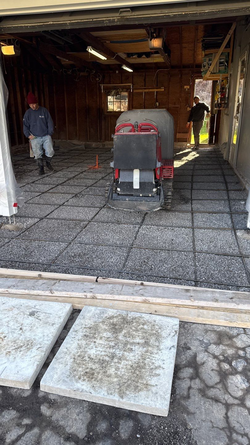 Concrete garage floor replacement with a broom finished apron and sidewalk  by NG Masonry & Construction LLC