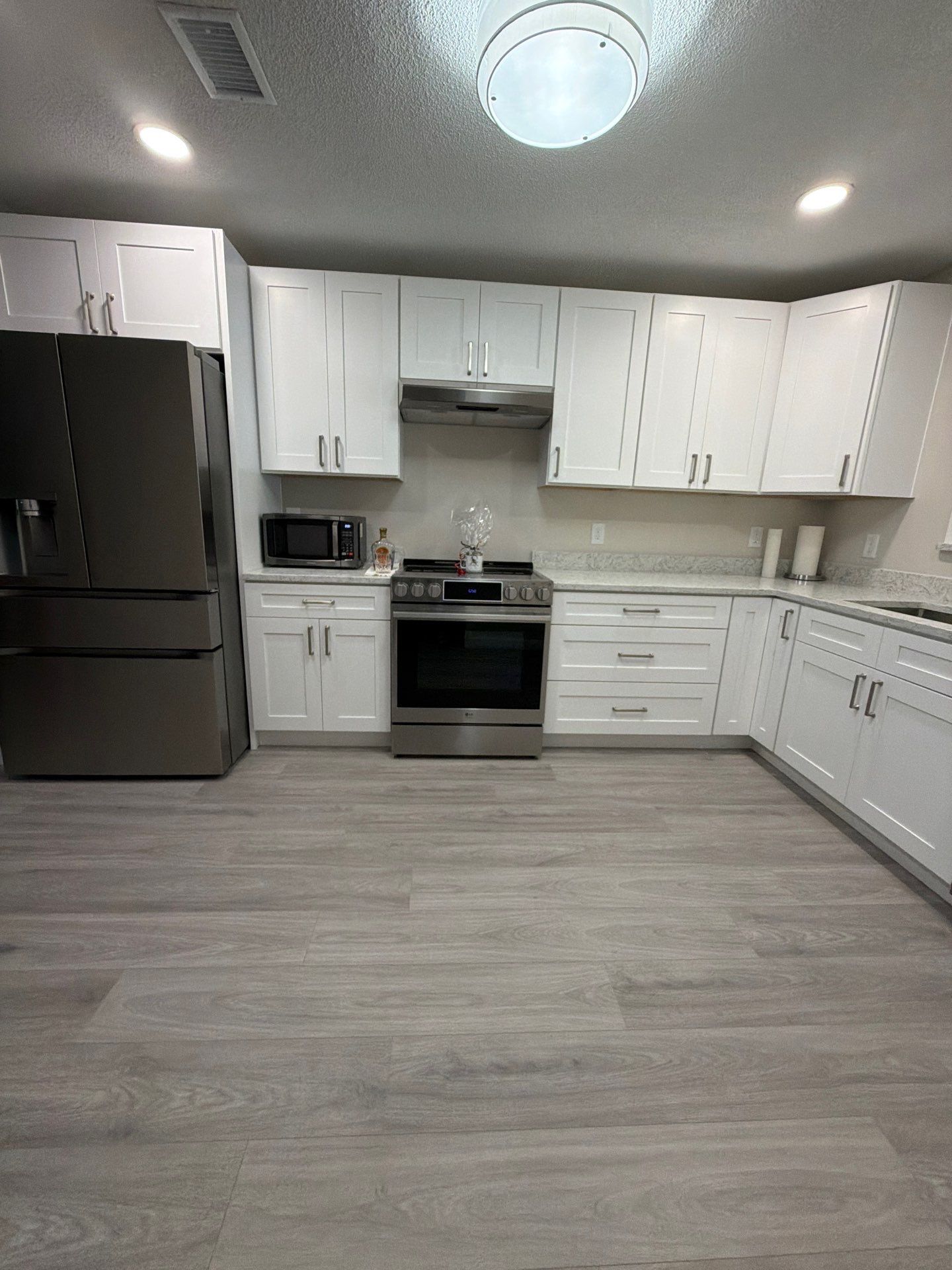Comprehensive Home Remodel featuring Bright Modern Kitchen by Acies Renovations