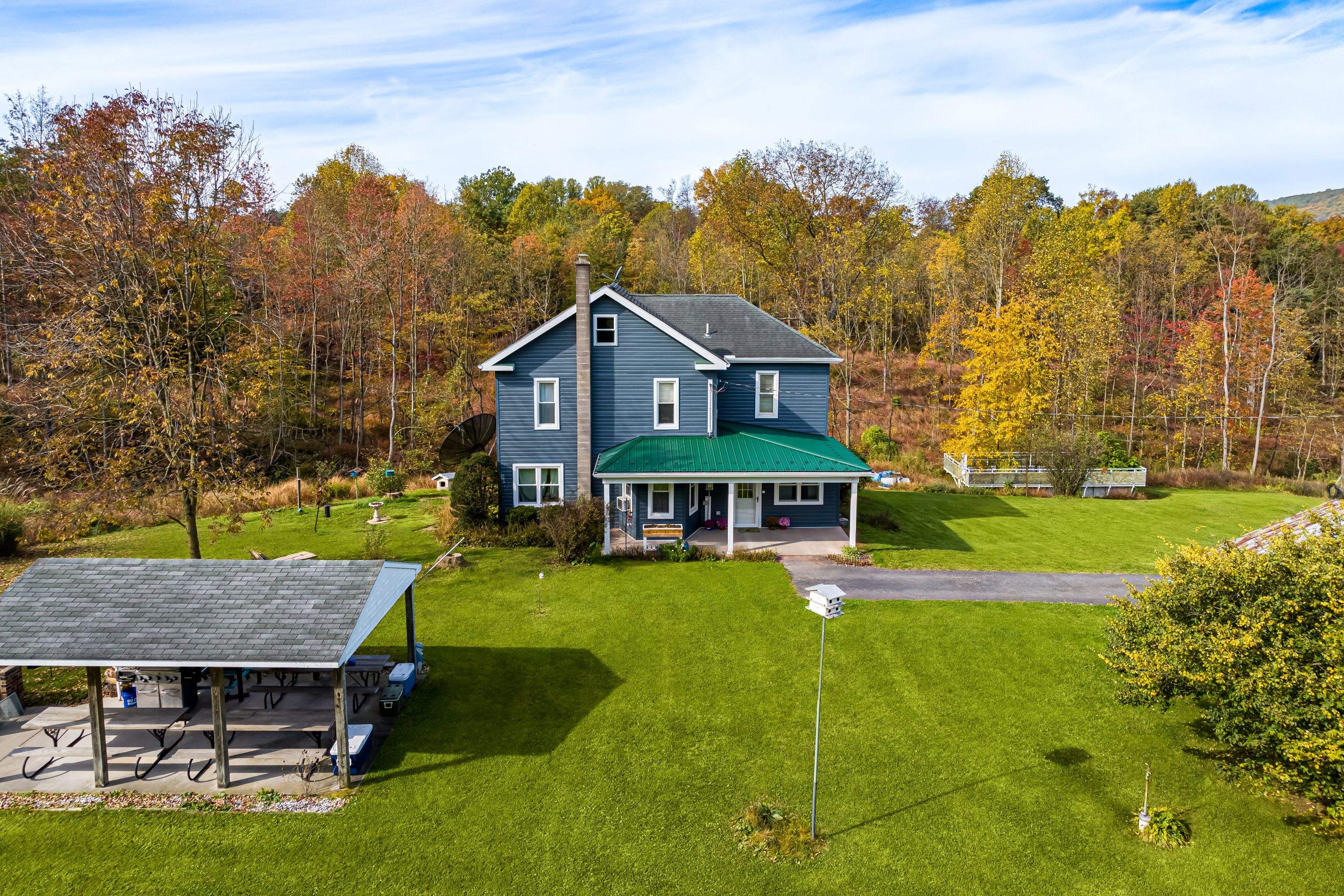 Porch roof [green] and new siding by Esh Builders