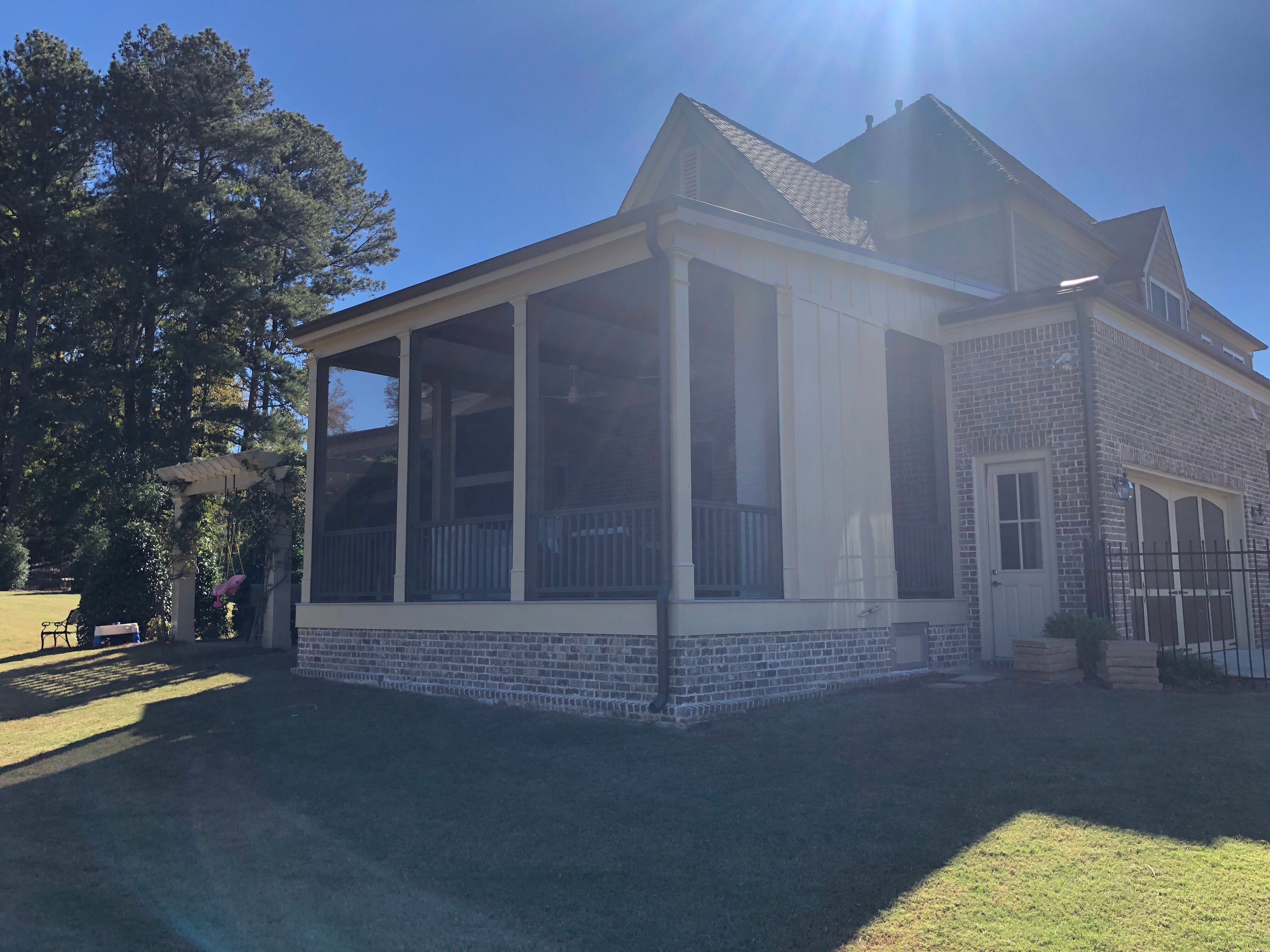 Custom Screened Porch Addition with White Brick Fireplace in Duluth by Swift Home Renovations