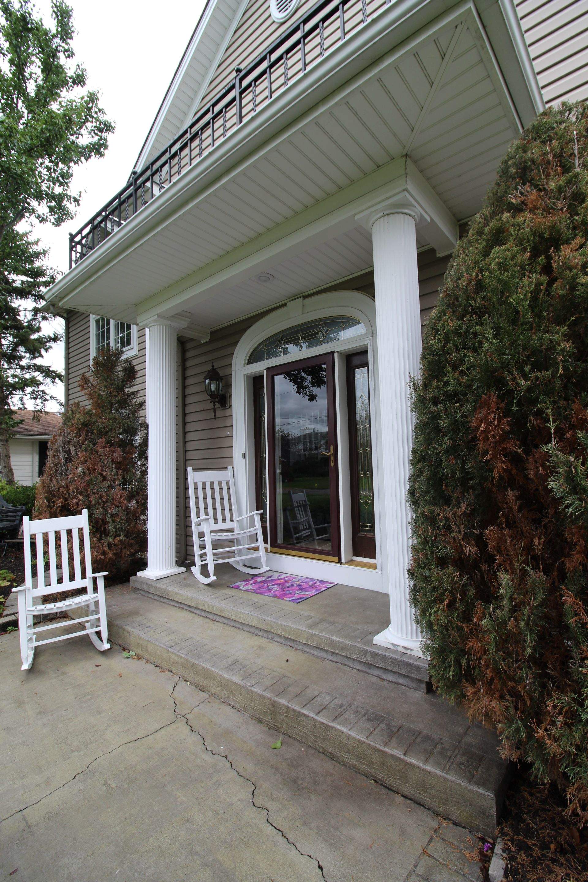 Exterior Renovations- Siding, Concrete, Railings, and Entry Door  by Ivy Lea Construction