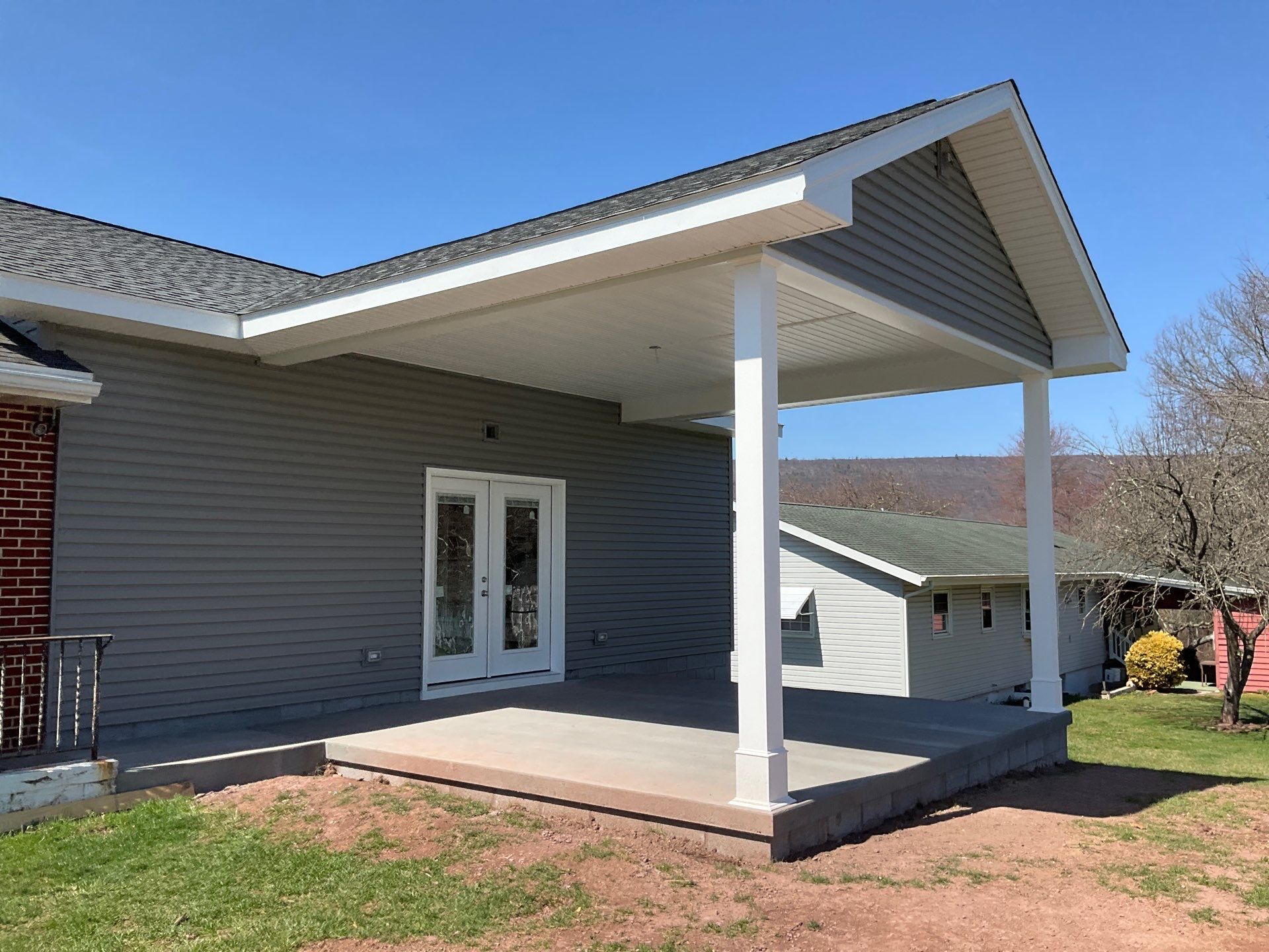 Tower City Residential Addition Featuring Gray Vinyl Siding and Garage by Esh Builders