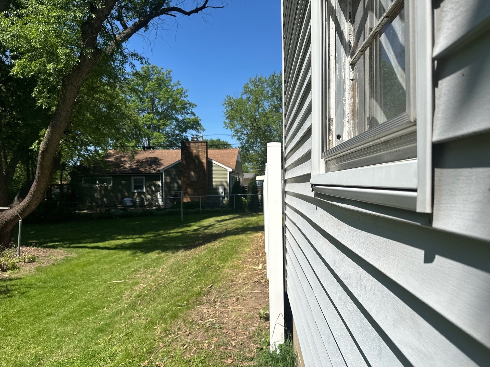 White Vinyl Privacy Fence and Double Gate Installation in Cedar Falls by Perfect Picket Fence and Stain