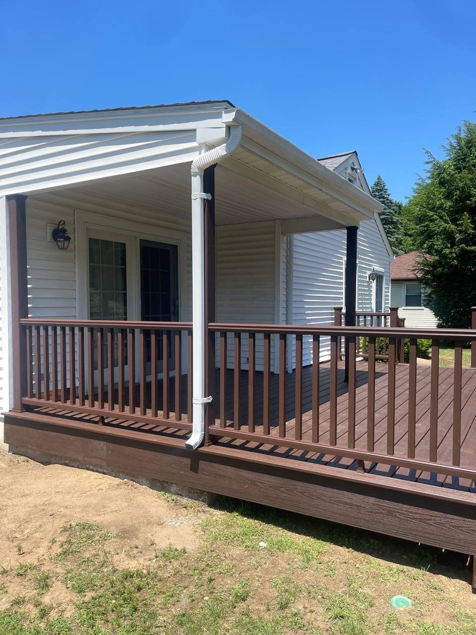 New deck using Trex Tropical Lava rock, Transcend railings in Vintage Lantern with matching fascia. by DiGiorgi Roofing and Siding Inc