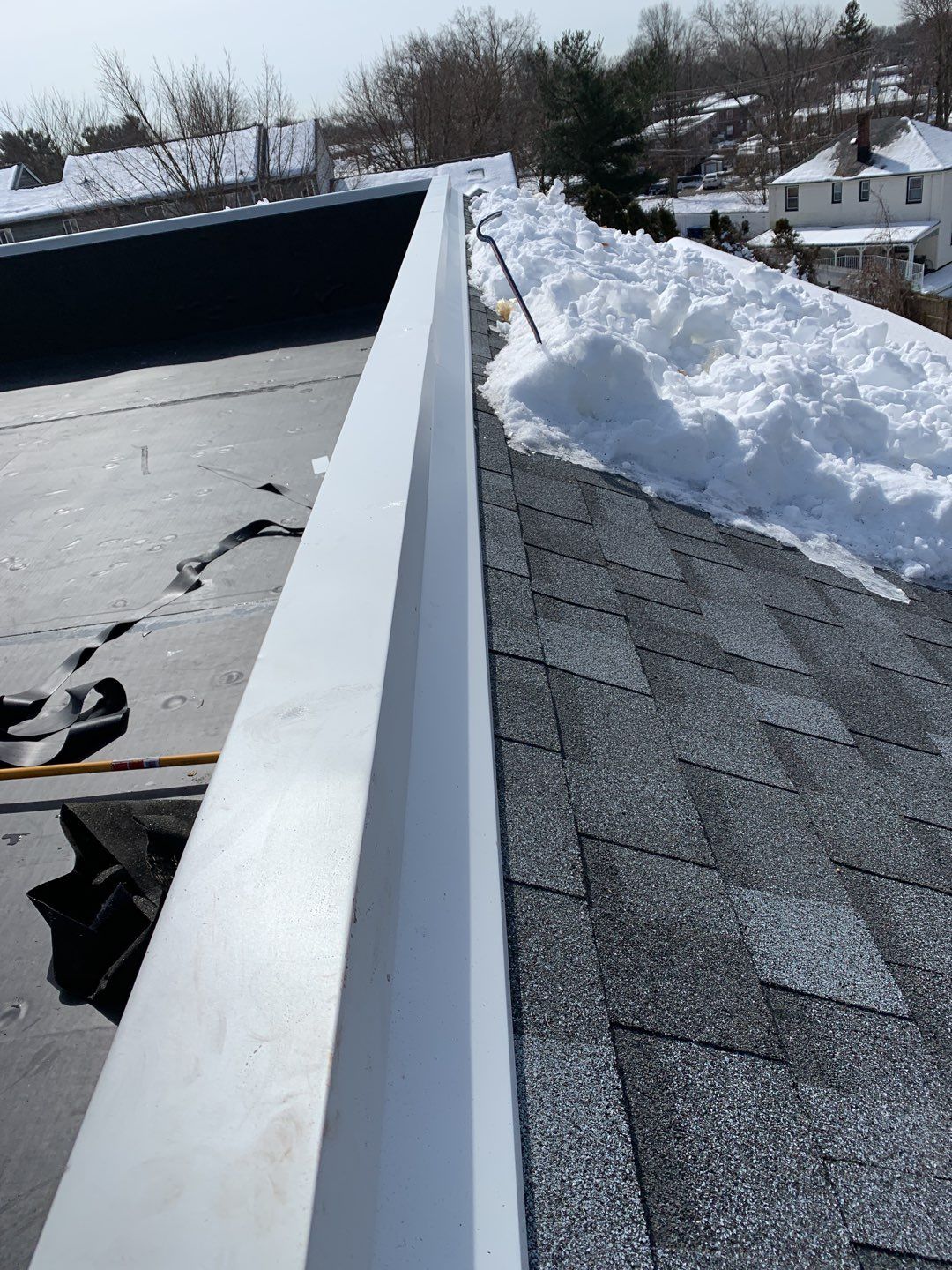 Commercial Roofing Installation using EPDM with white gutters by A Plus Exterior