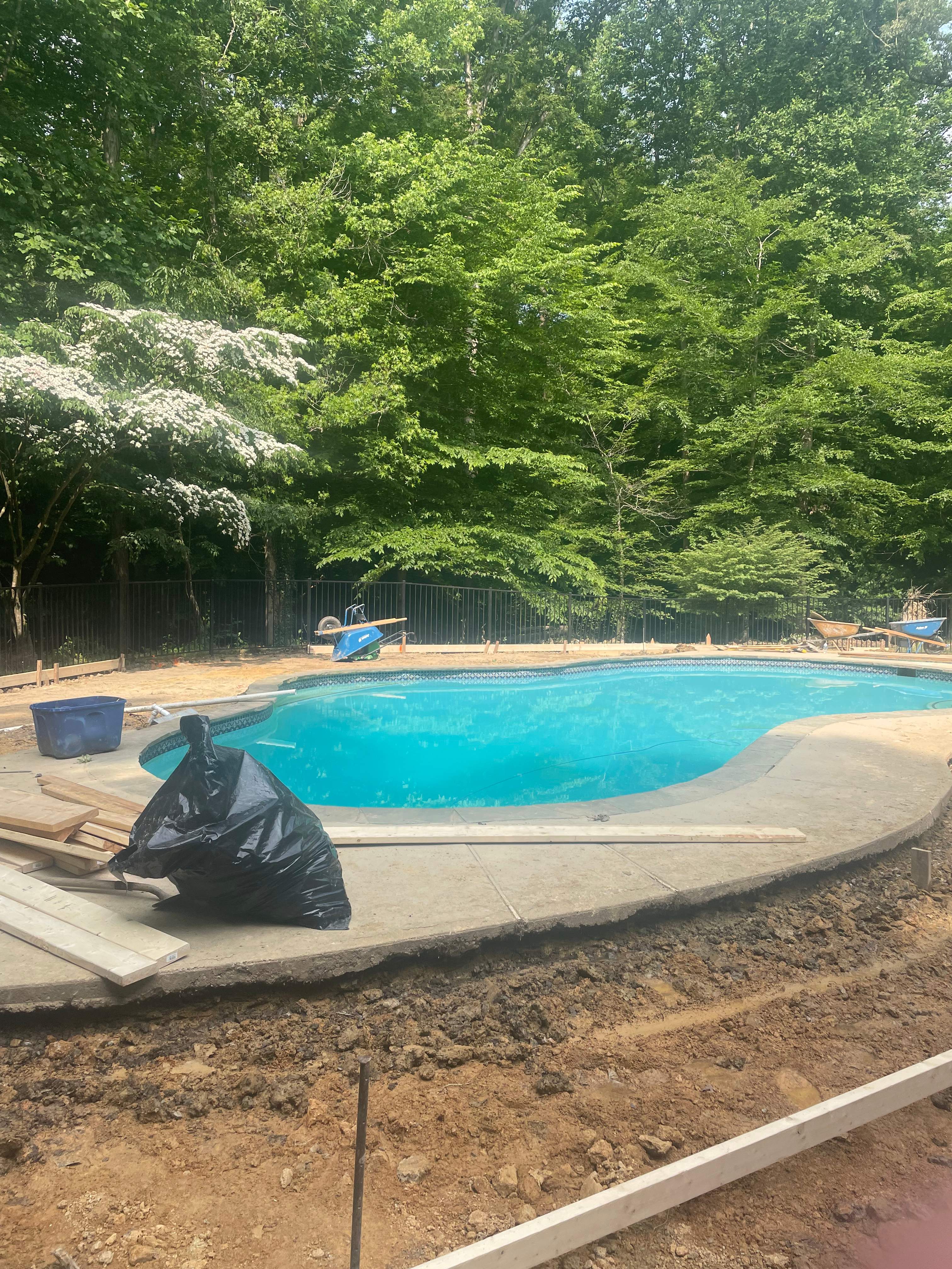Pool Surround remodel with retaining walls, new waterfall and water slide by Fairfax Contractors, LLC