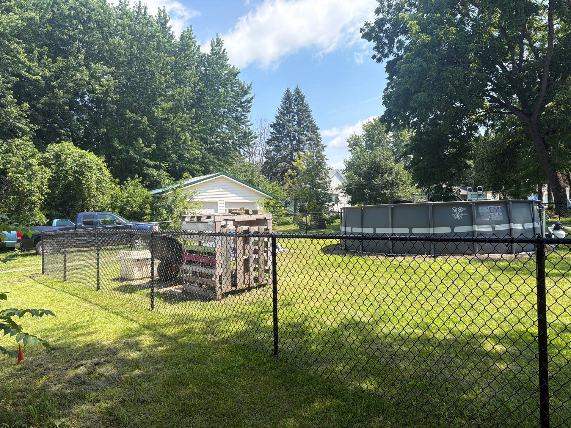 Black Chain Link Backyard Fence Installation in Tripoli, IA by Perfect Picket Fence and Stain