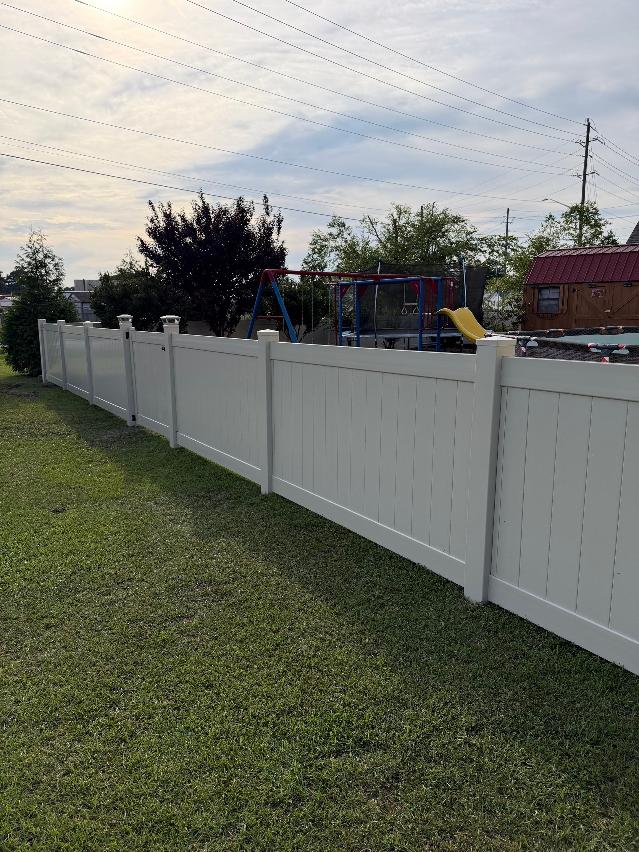 Residential Tan Vinyl Privacy Fence Installation in Winterville by Superior Fence and Rail