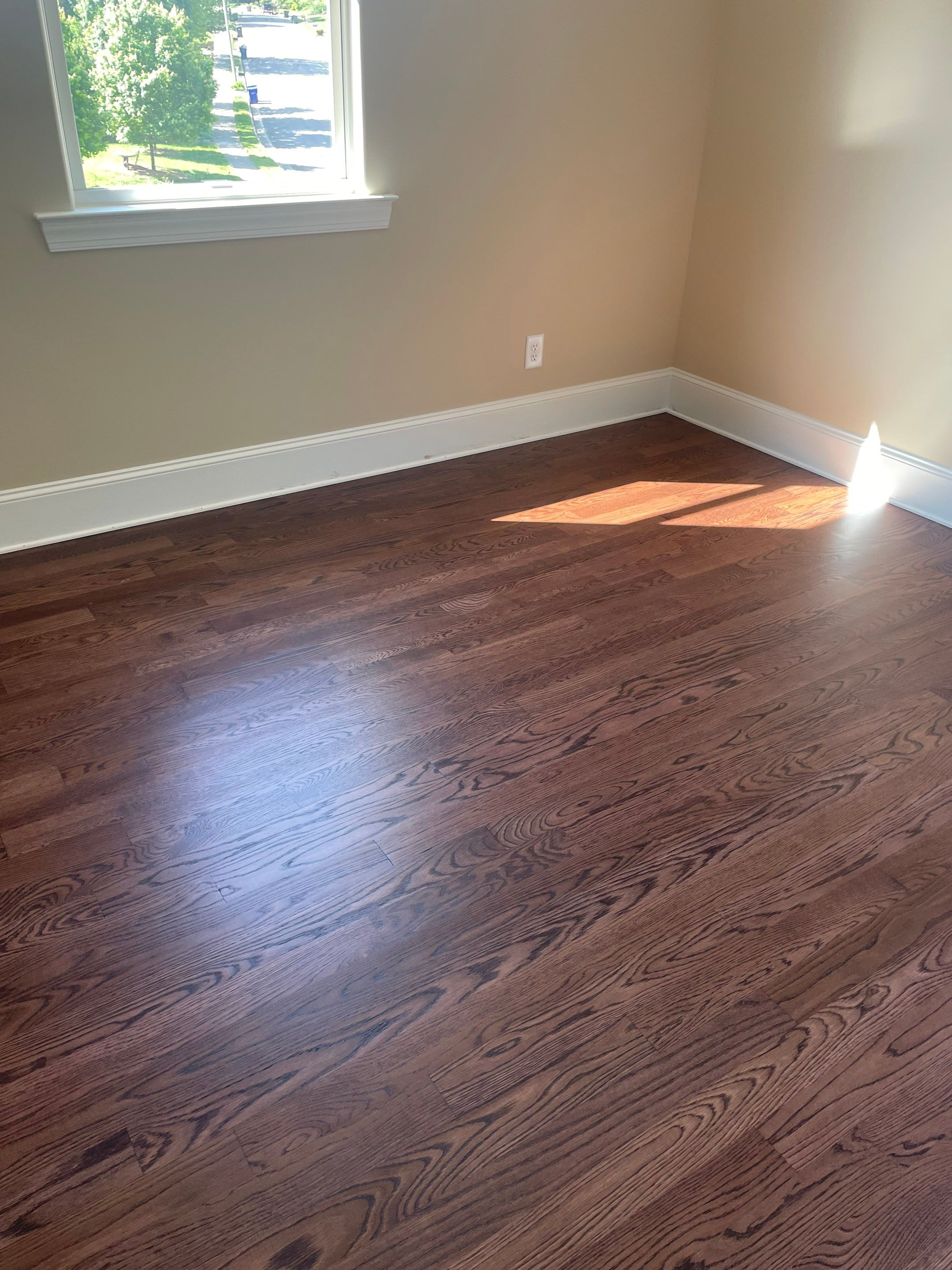 New white oak floors, stained a red tone. by Accent Custom Floors