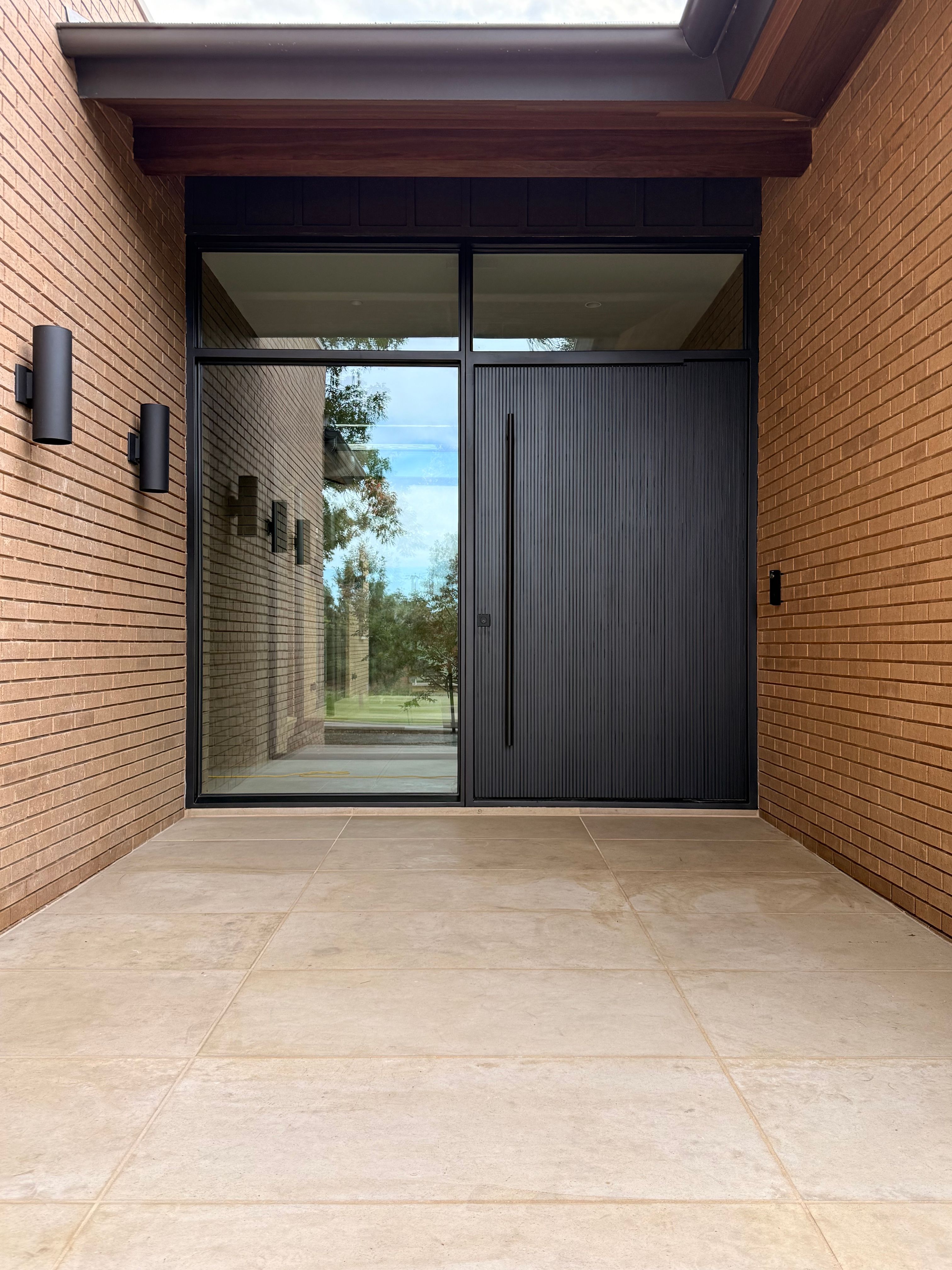 Custom Steel Oporto Pivot Door Installation for Dallas New Construction by Solara Custom Living