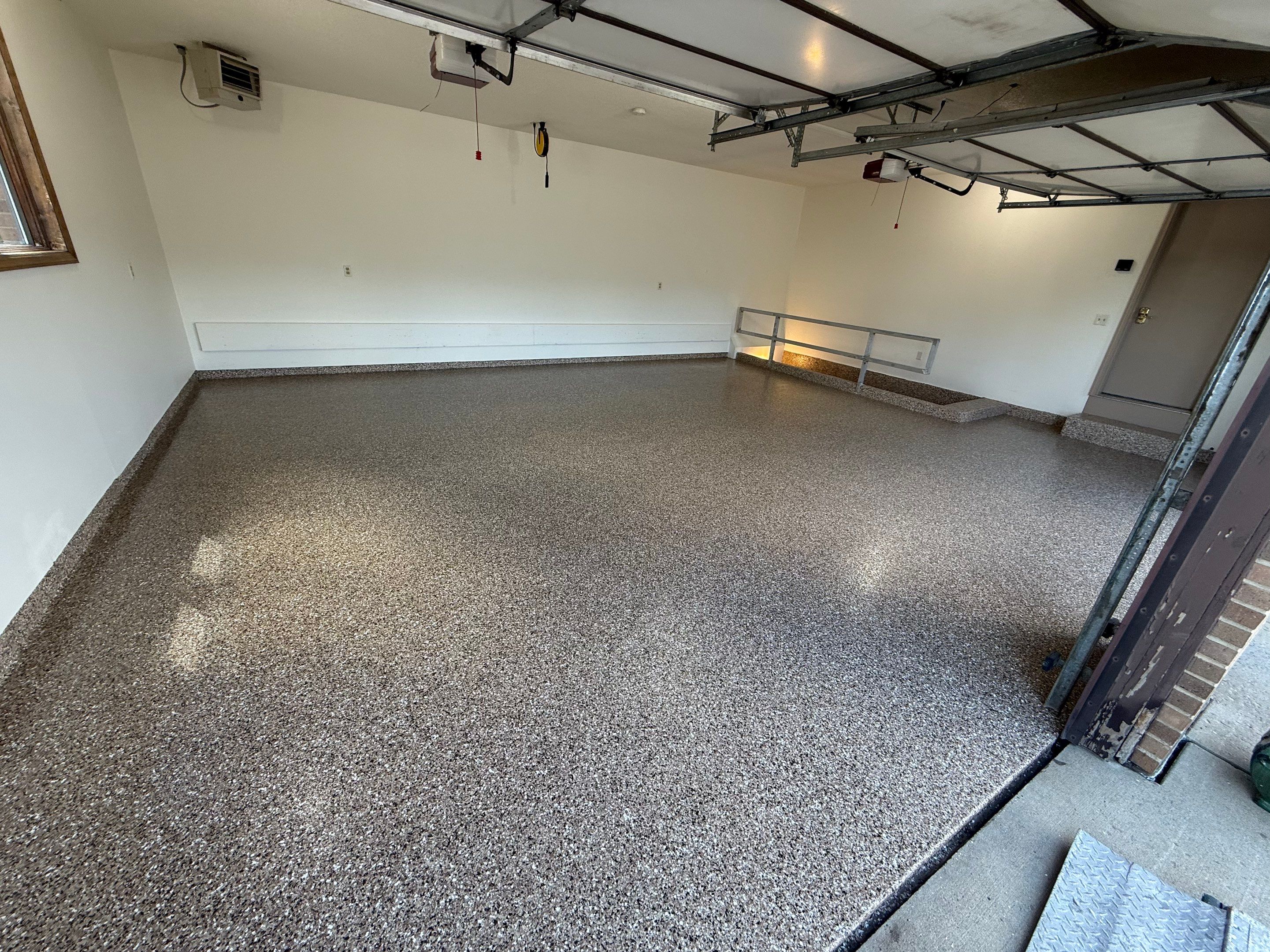 Custom Polyaspartic Garage Floor and Stairwell Coating in Pipestone by Select Painting, Coatings & Garage Cabinets