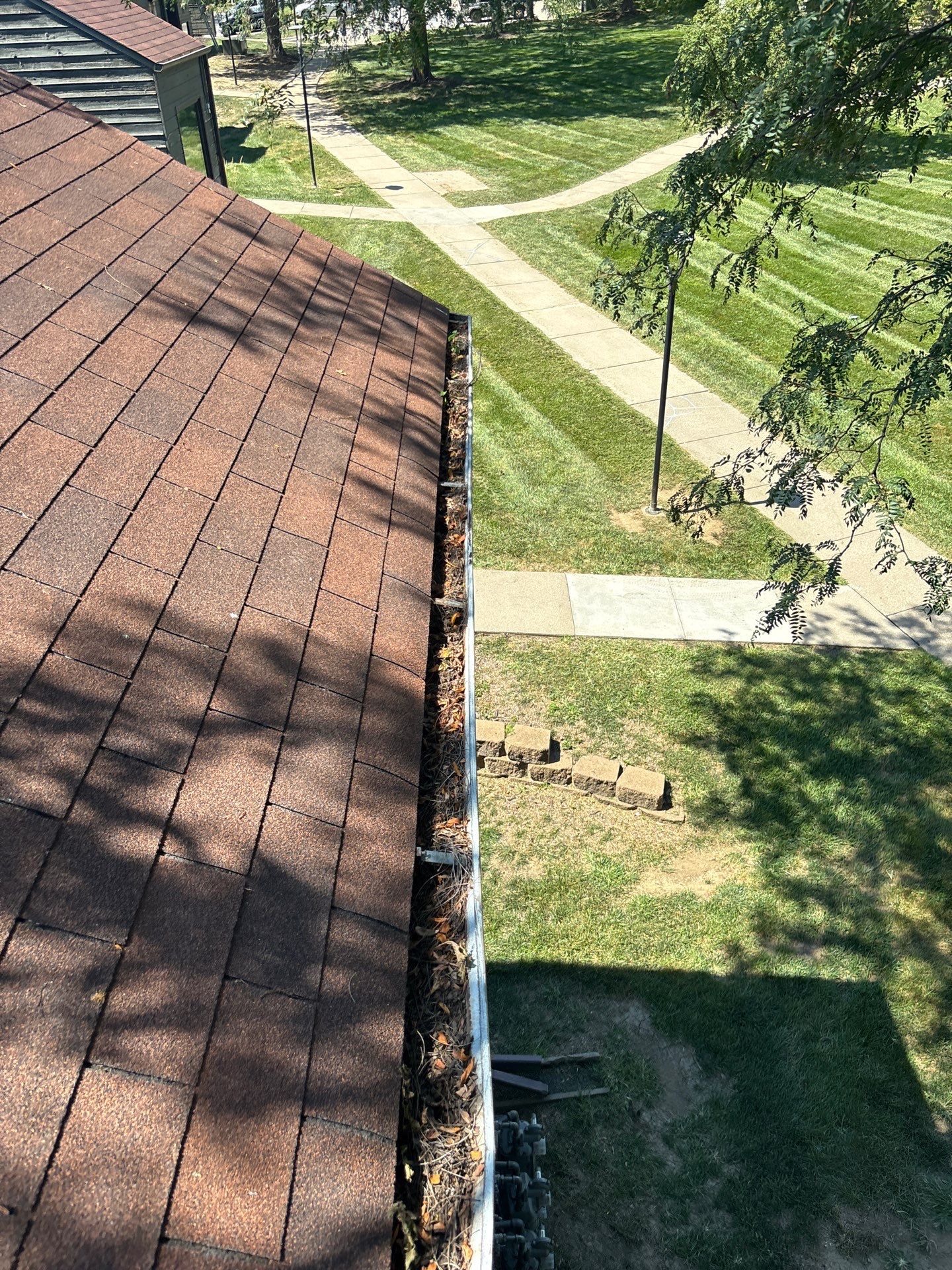 Commercial gutter cleaning Omaha before photo with filled gutters