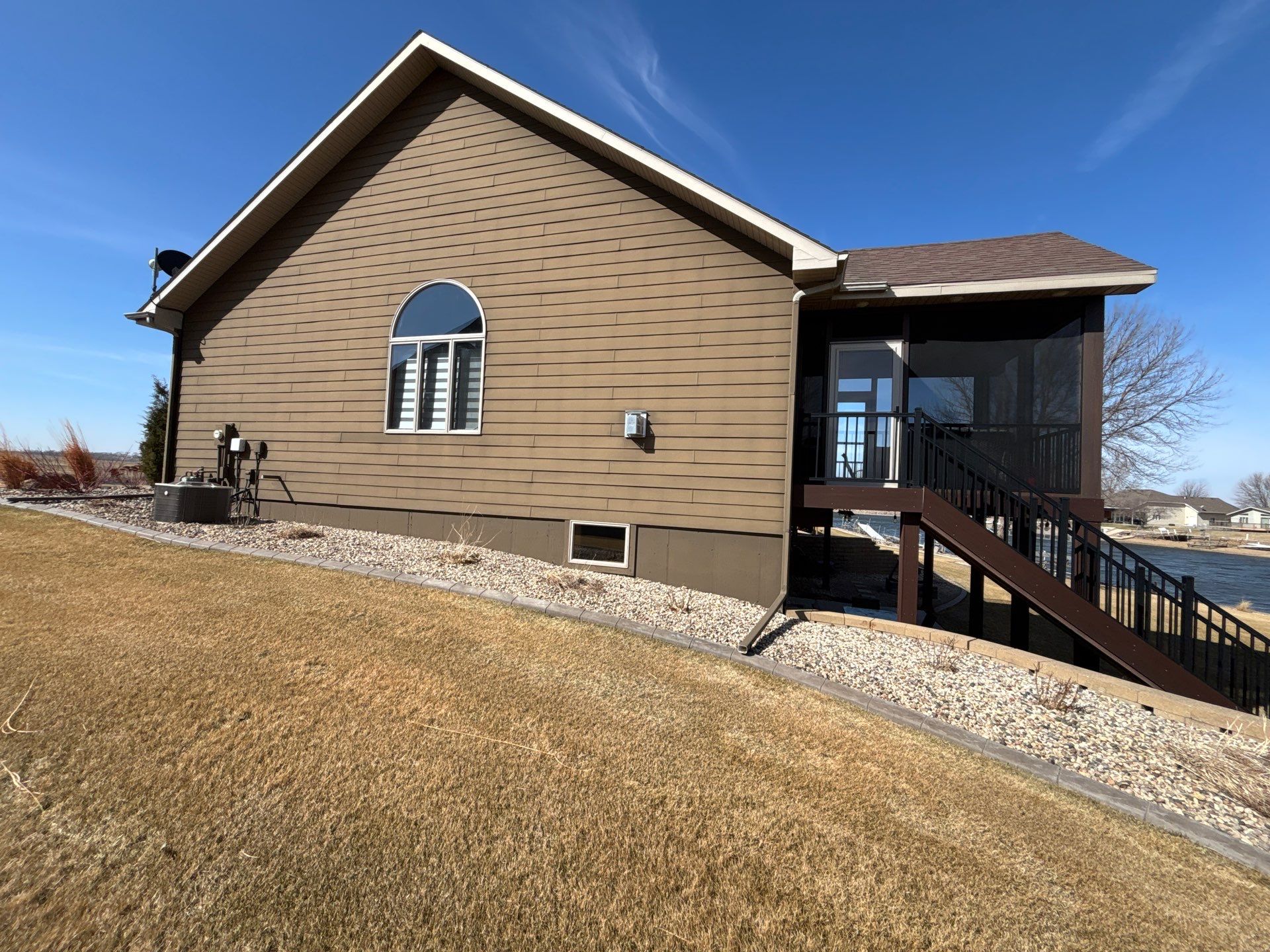 Full Exterior Renovation with Stone Veneer and Composite Decking by Select Painting, Coatings & Garage Cabinets