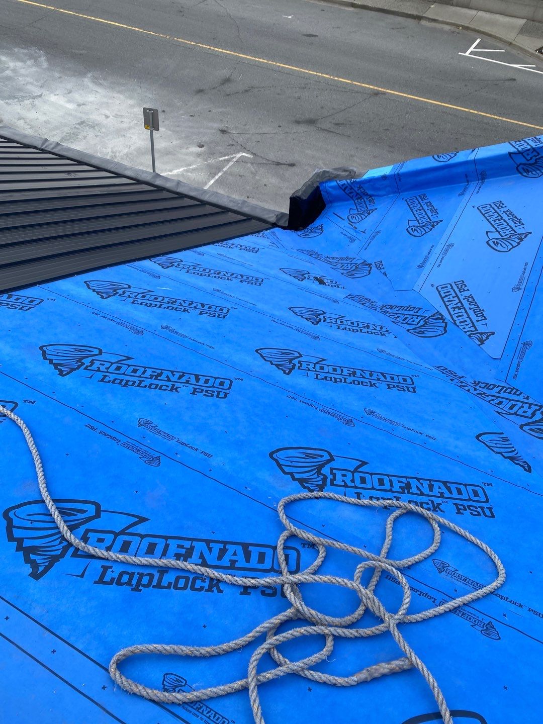 Commercial Roofing Installation using 12" Prolok metal and hidden gutters! by Top Notch Roofing Inc