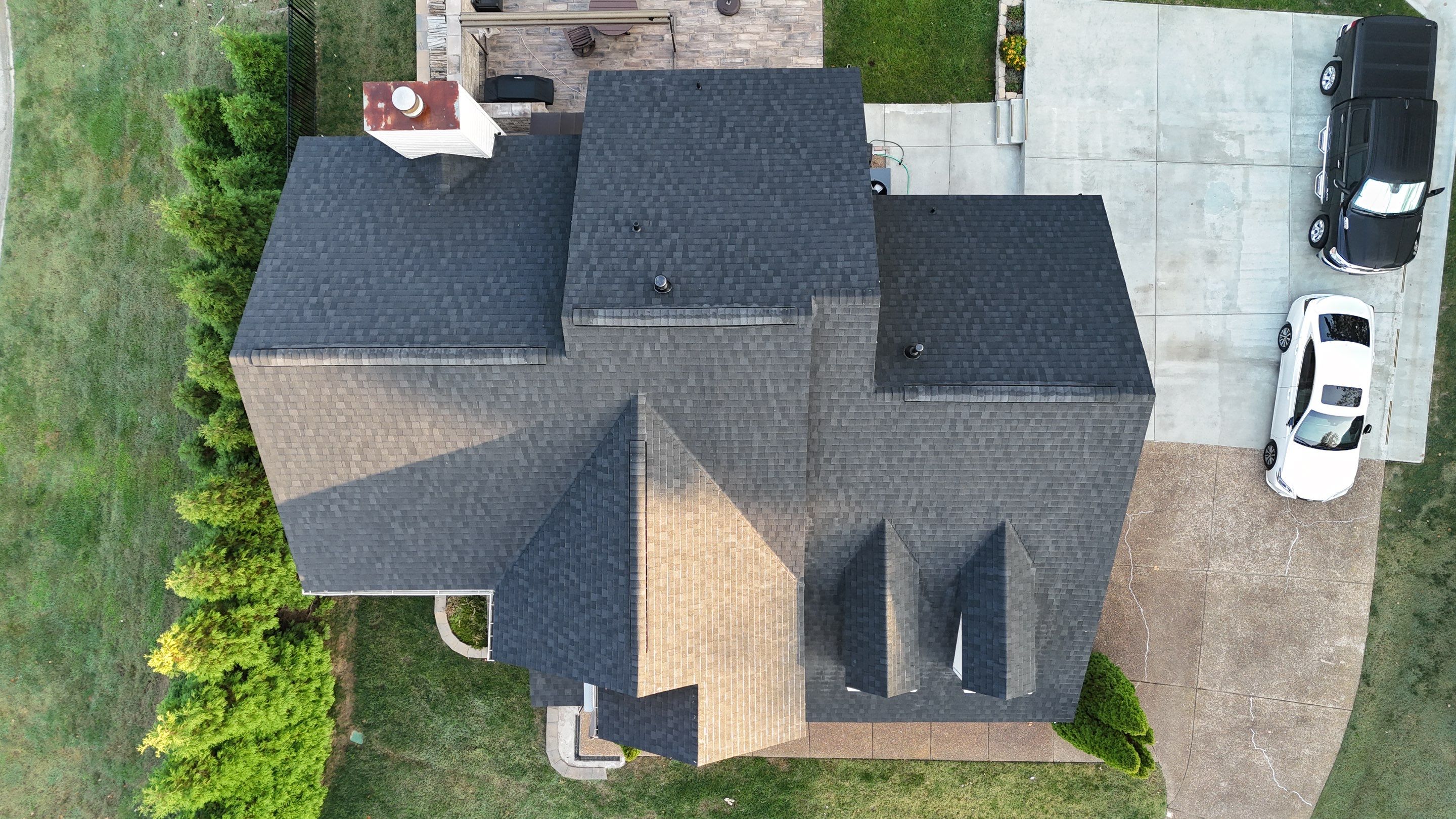 Charcoal Black Re-Roof & Gutters by Royal House LLC