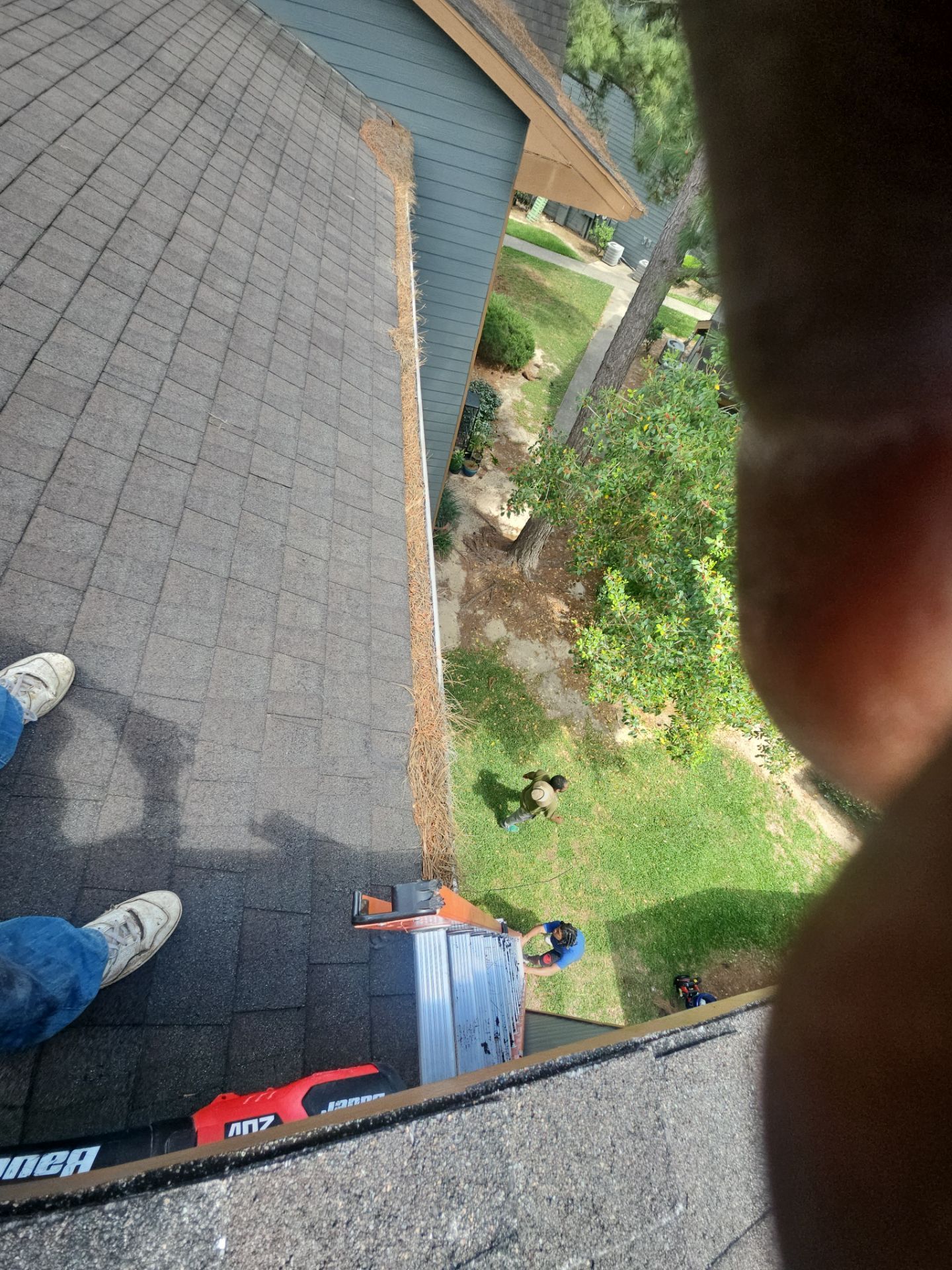 Commercial gutter cleaning Beaumont & Port Arthur before photo with filled gutters