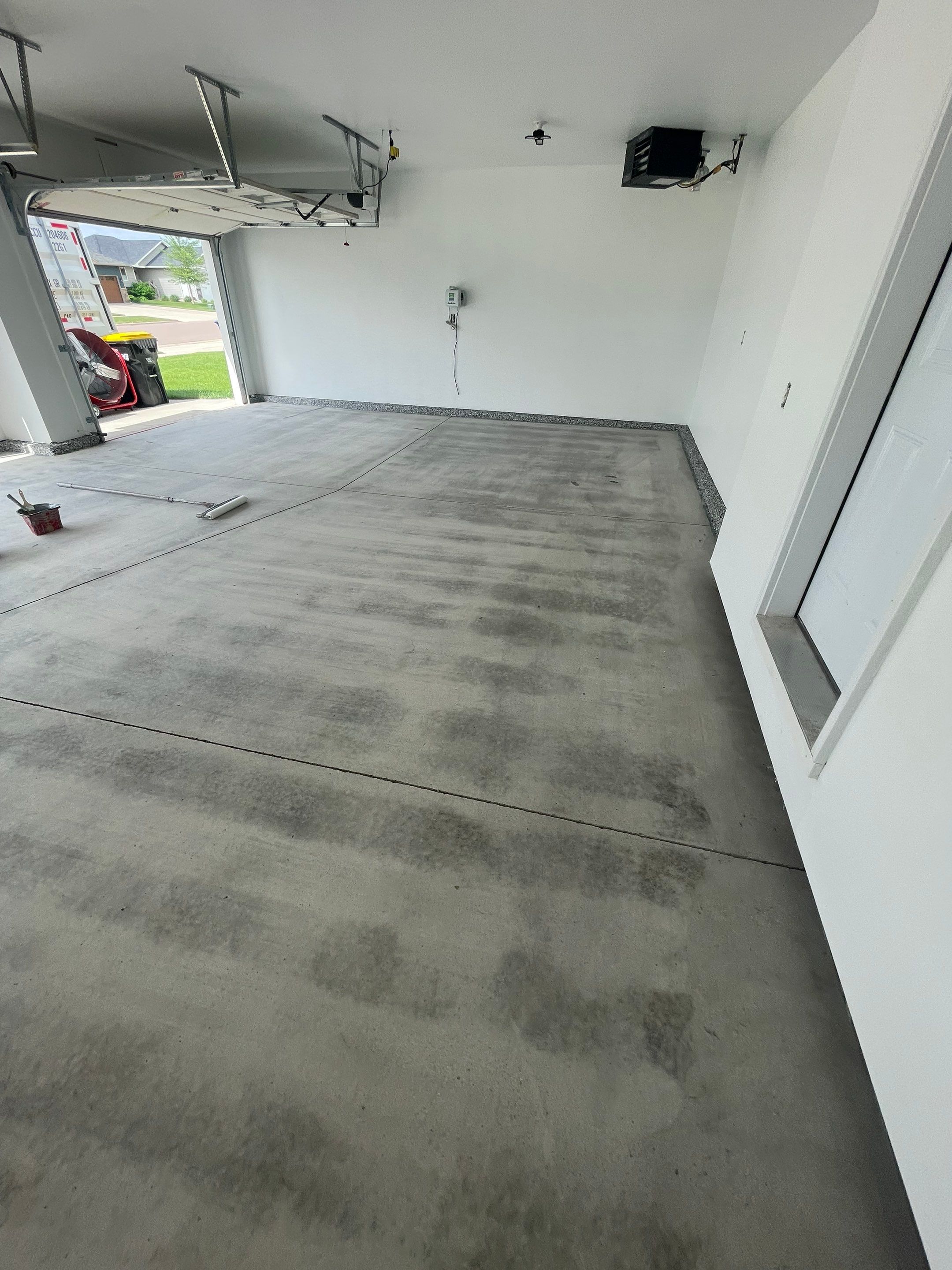 Grey Flake Epoxy Garage Floor Coating in Sioux Falls by Select Painting, Coatings & Garage Cabinets